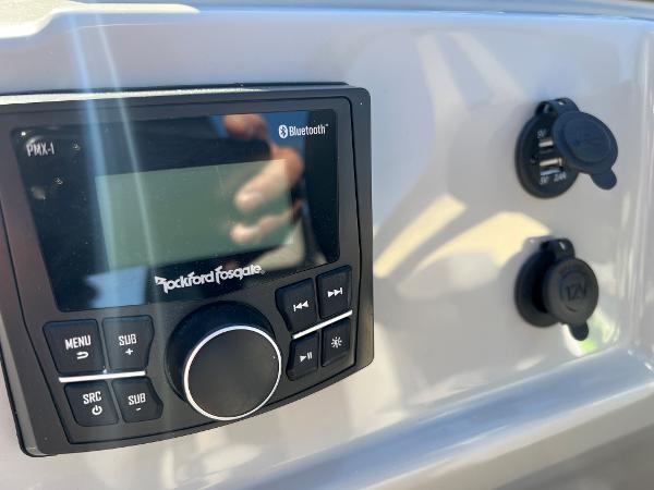 Close-up of a boat control panel with Rockford Fosgate Bluetooth system.