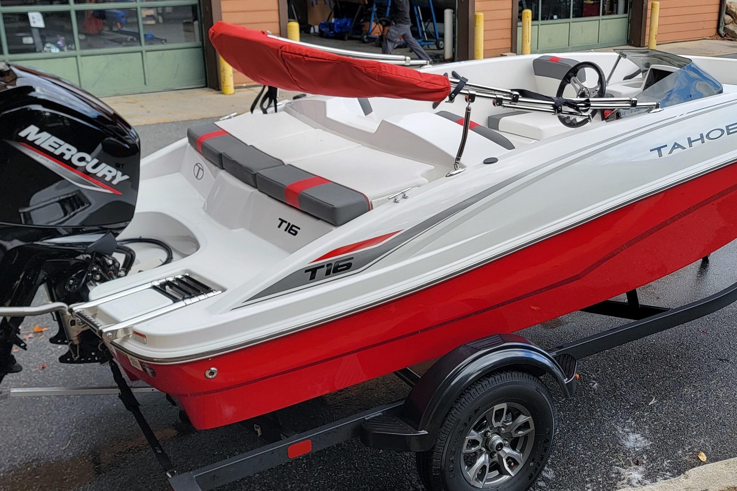 2026 Tahoe T16 boat with Mercury engine, red and white design, on a trailer.