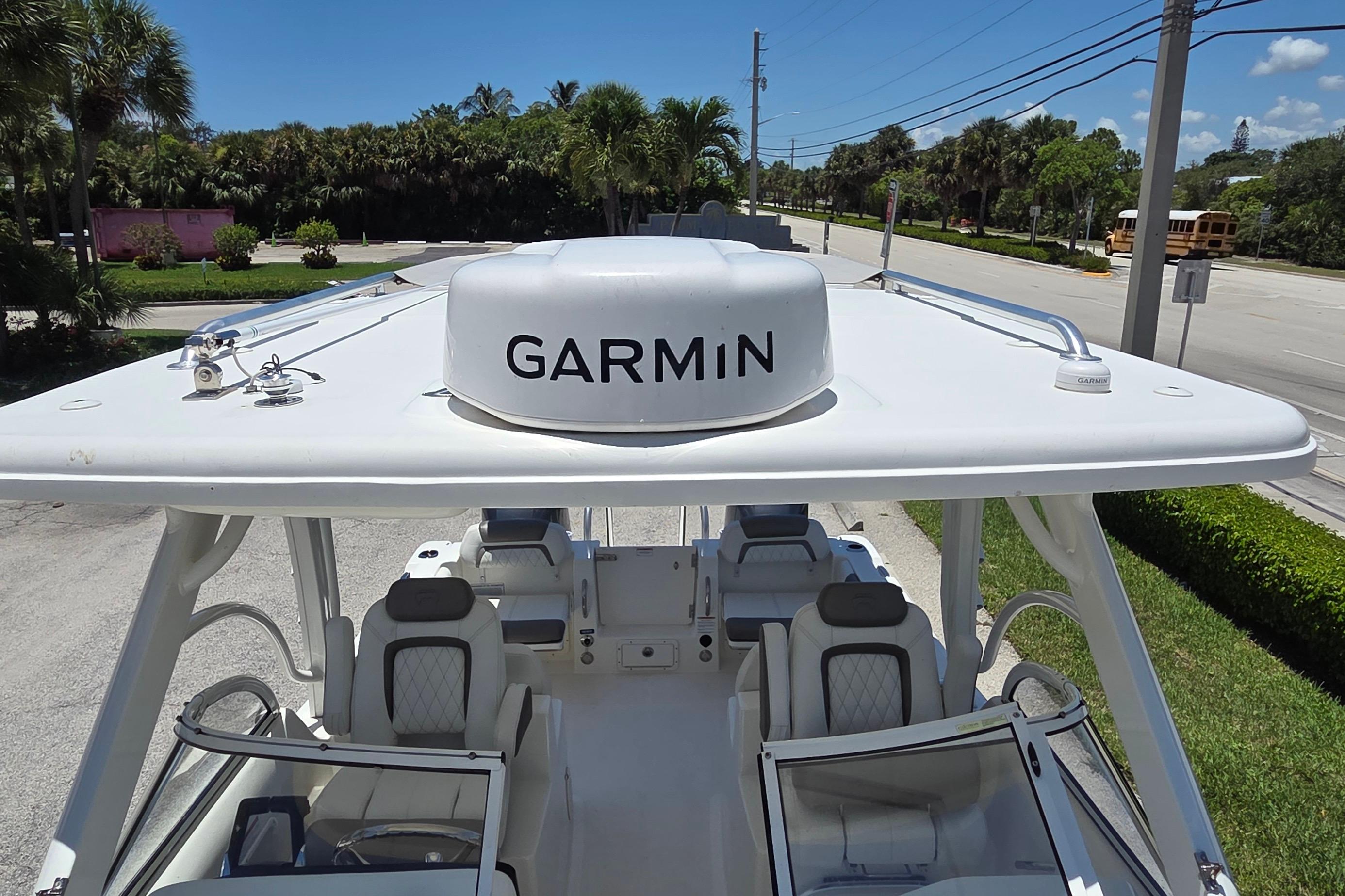 2022 World Cat 255 DC boat with Garmin radar, parked on a sunny street.