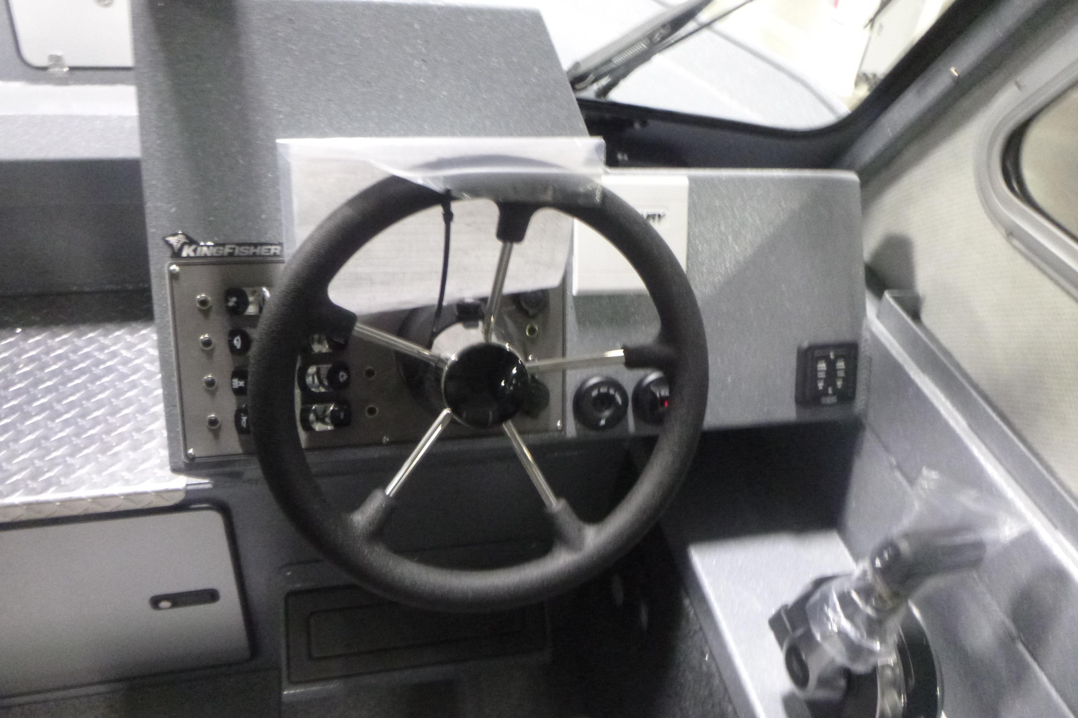 Steering wheel and controls of 2026 KingFisher 2425 Escape HT boat.