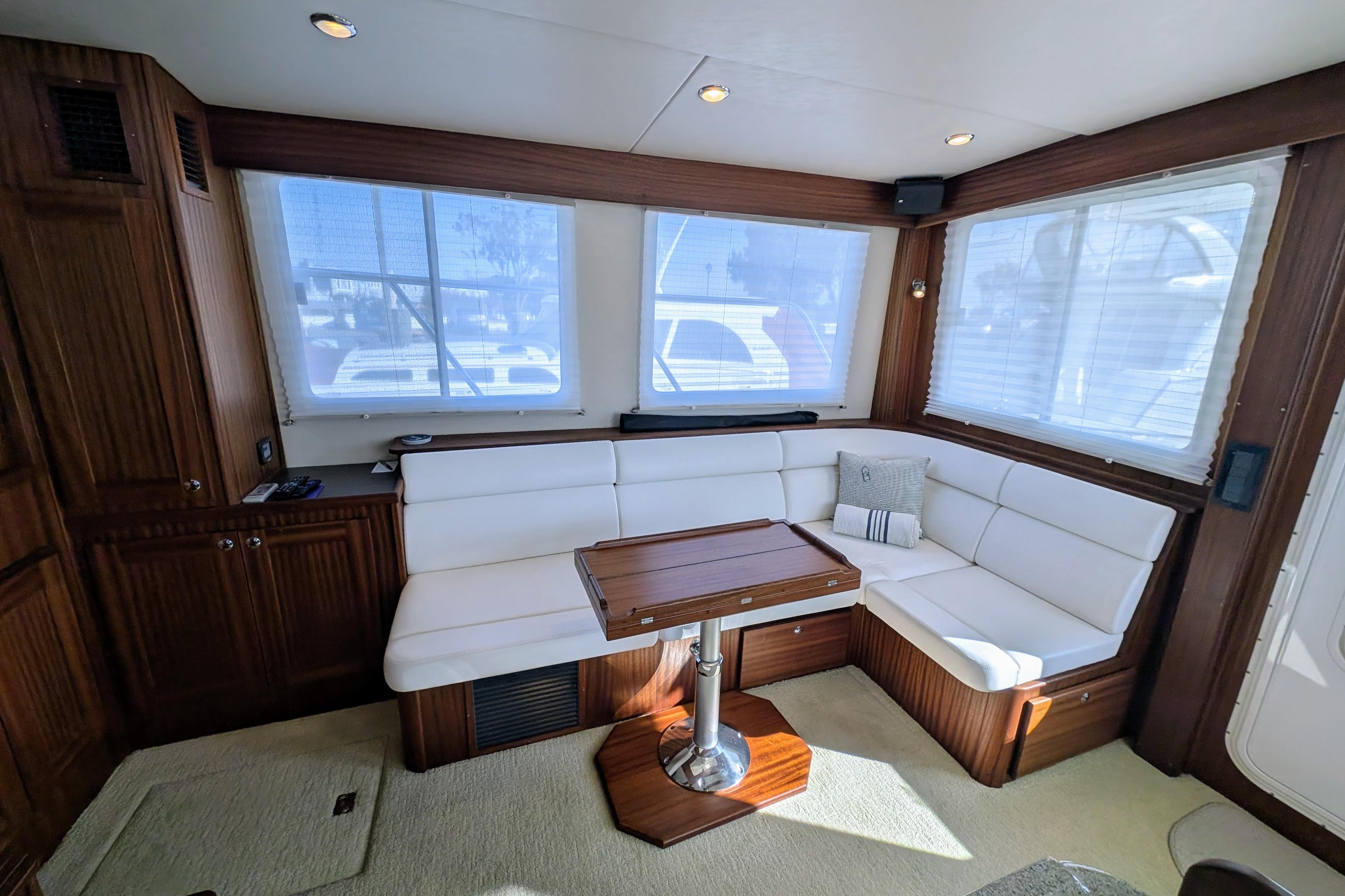 Luxurious interior of 2015 American Tug 435 with white seating and wooden accents.