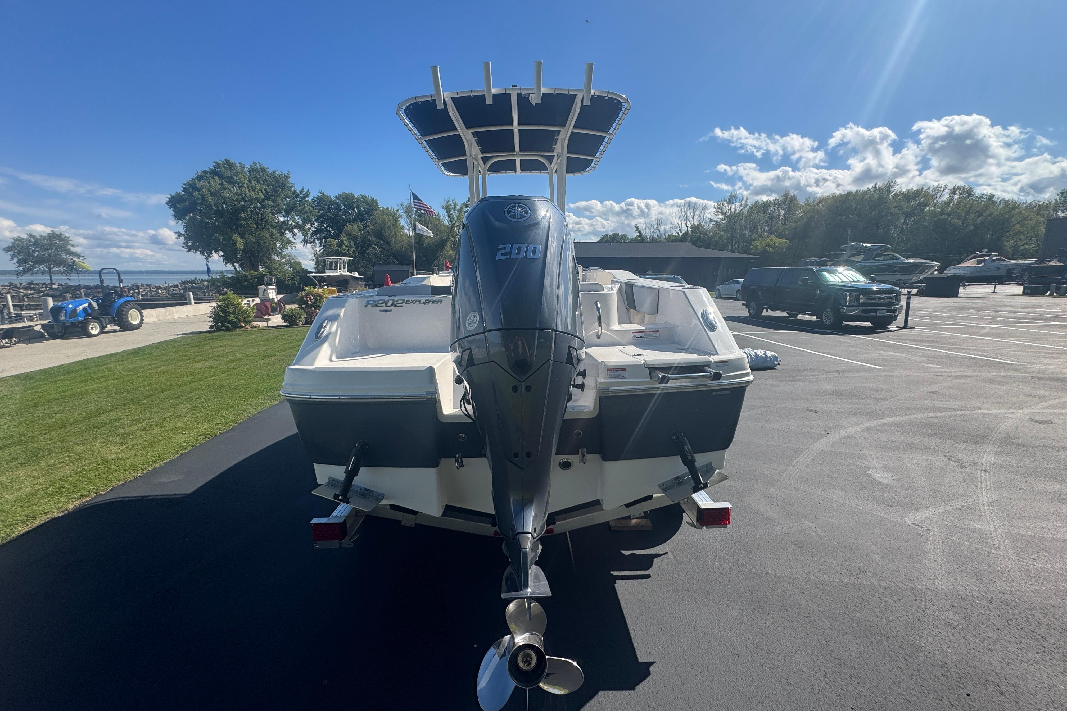2026 Robalo R202 Explorer boat with powerful outboard motor in a sunny marina setting.