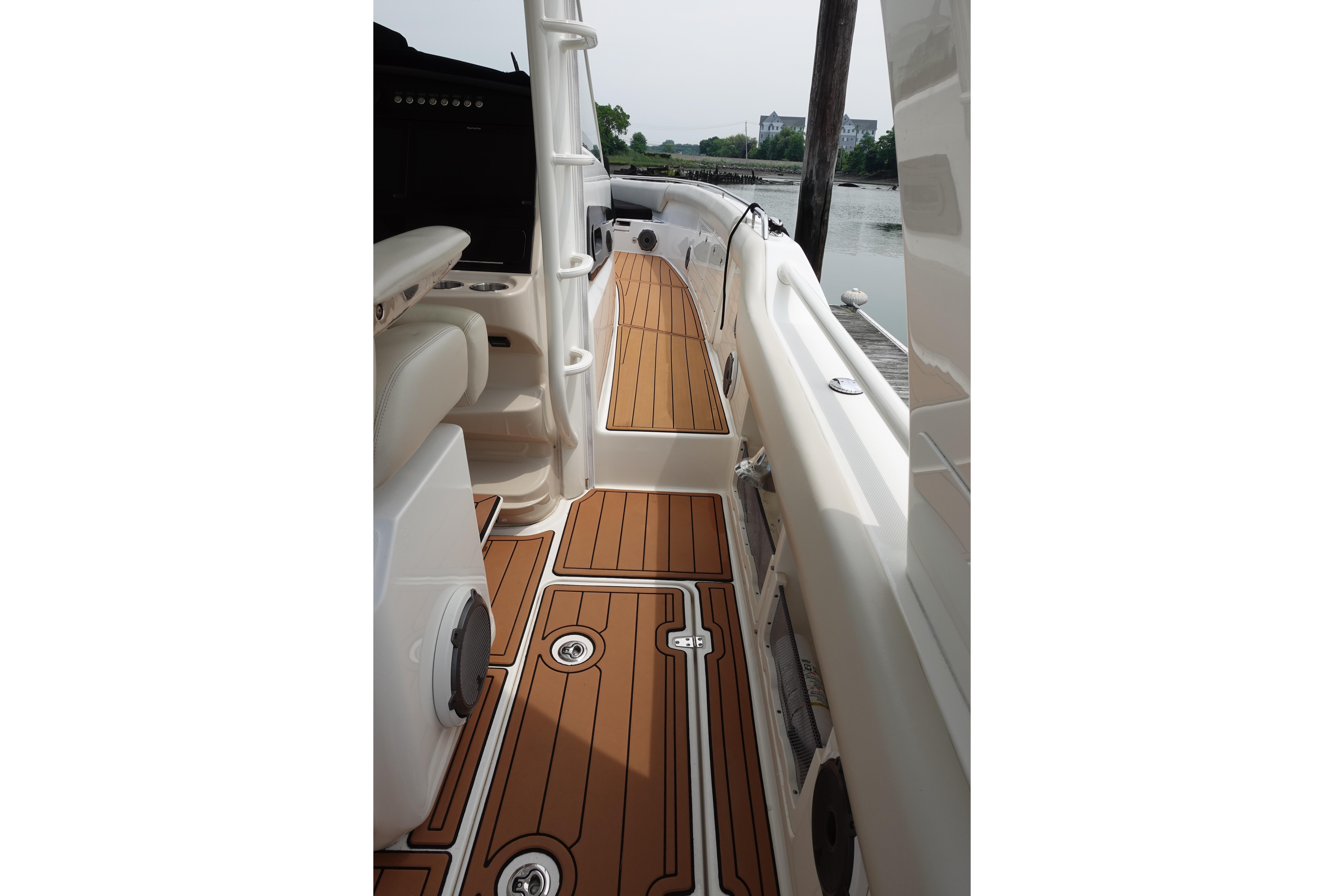 2020 Boston Whaler 420 Outrage boat deck with teak flooring and sleek design.