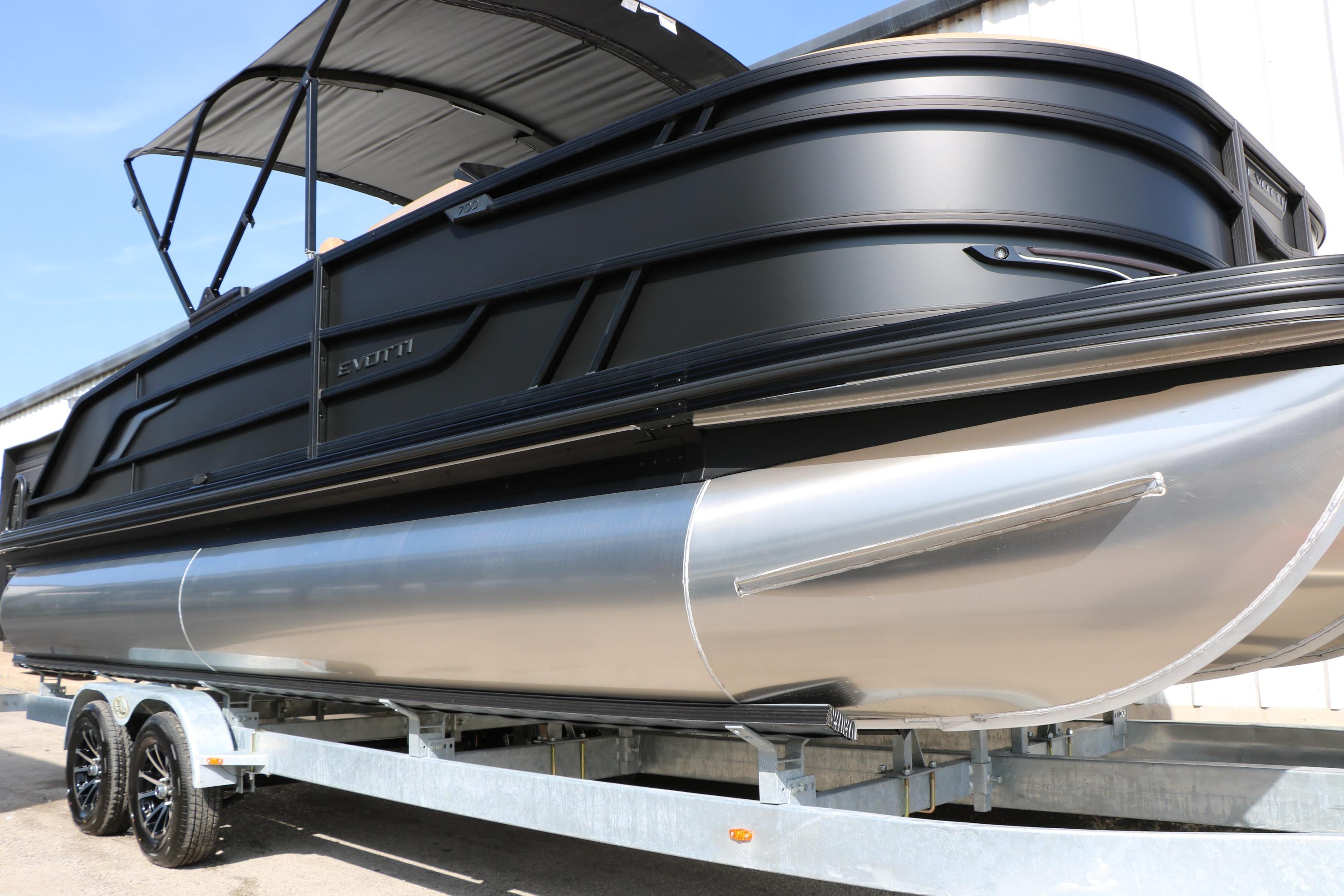 2026 Evotti 723CS pontoon boat on trailer, featuring sleek black design and canopy.