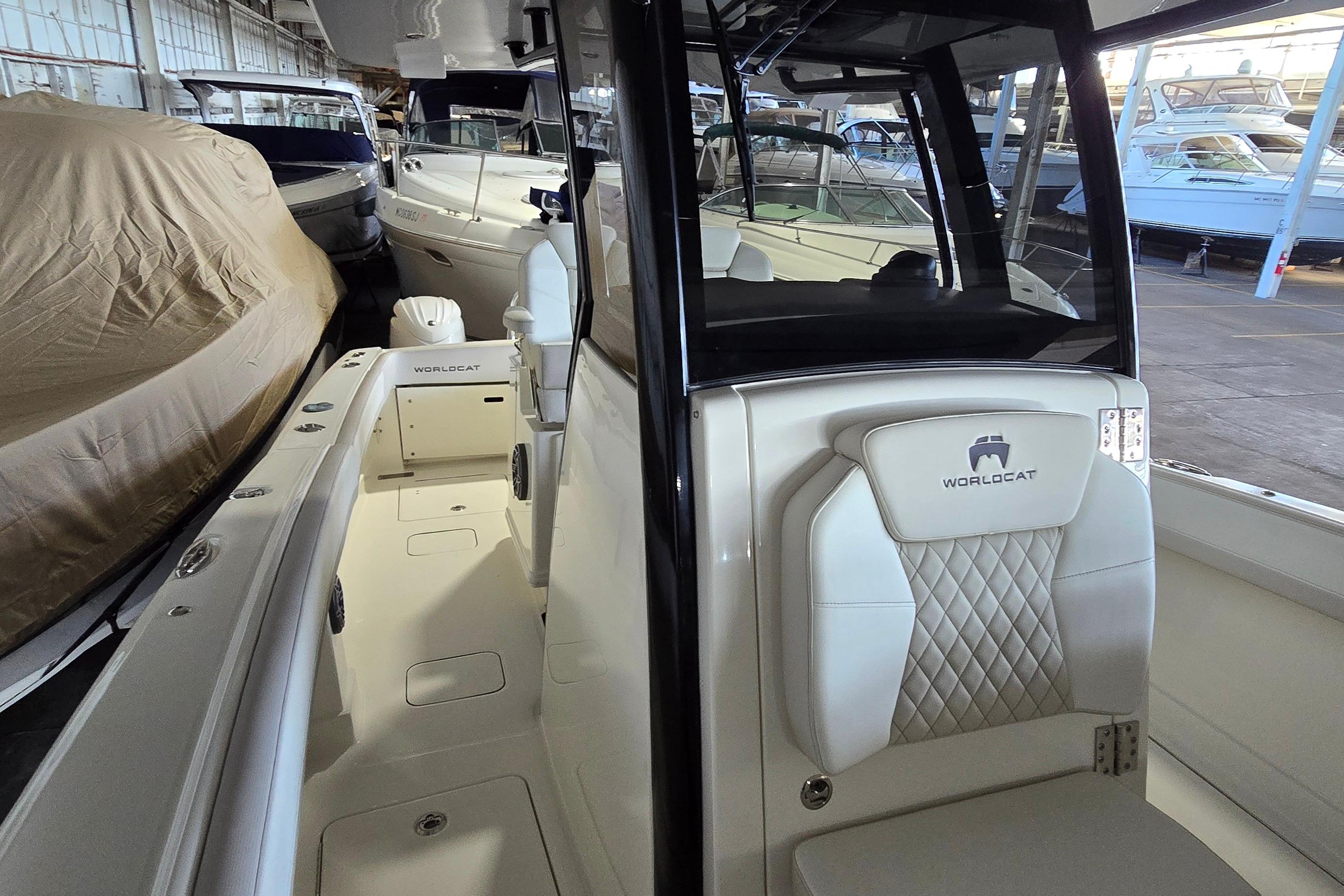 2024 WorldCat 280 CC-X boat interior with luxurious seating in a marina setting.