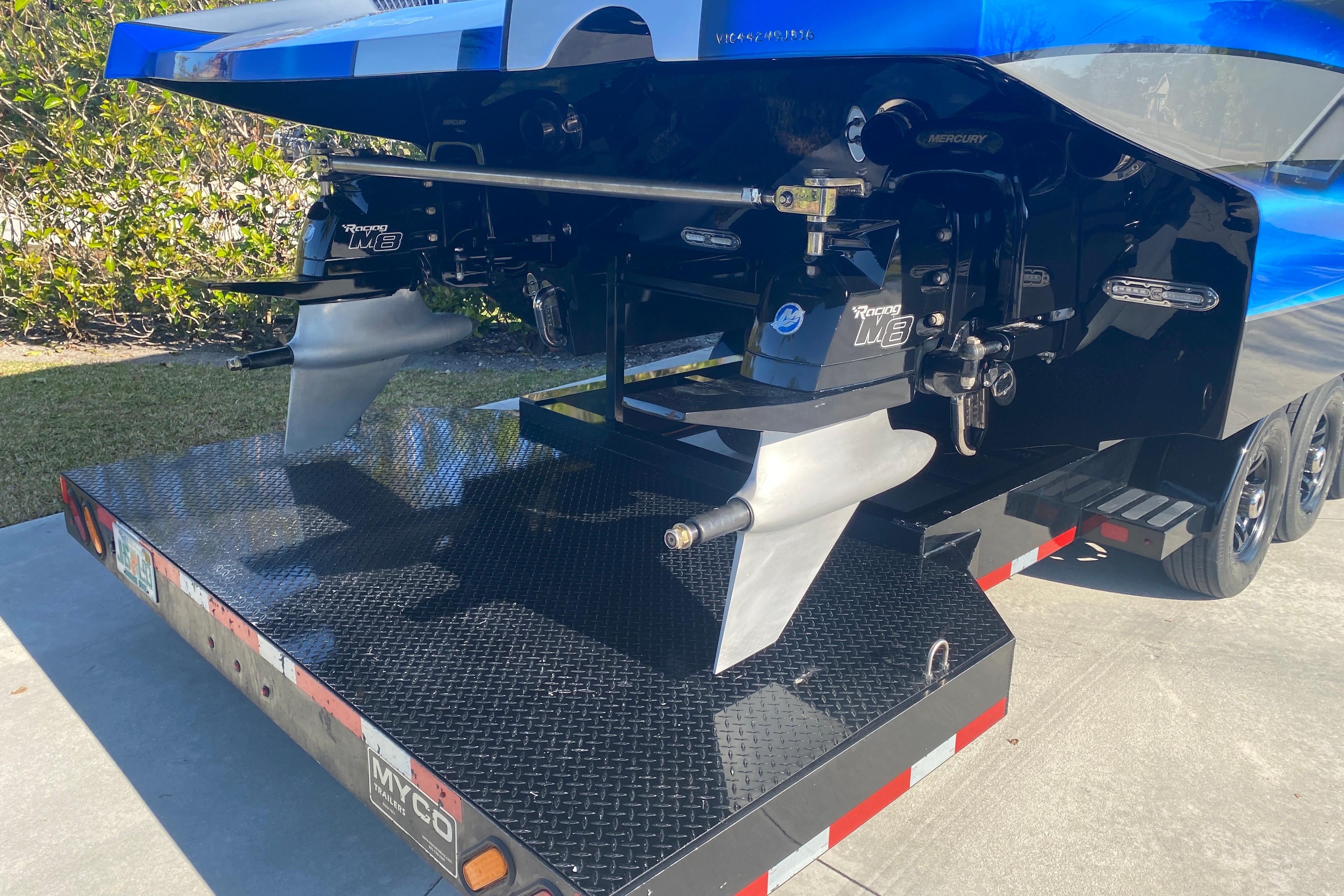 Rear view of a 2016 MTI 44 RP boat on a trailer, showcasing dual Mercury Racing engines.