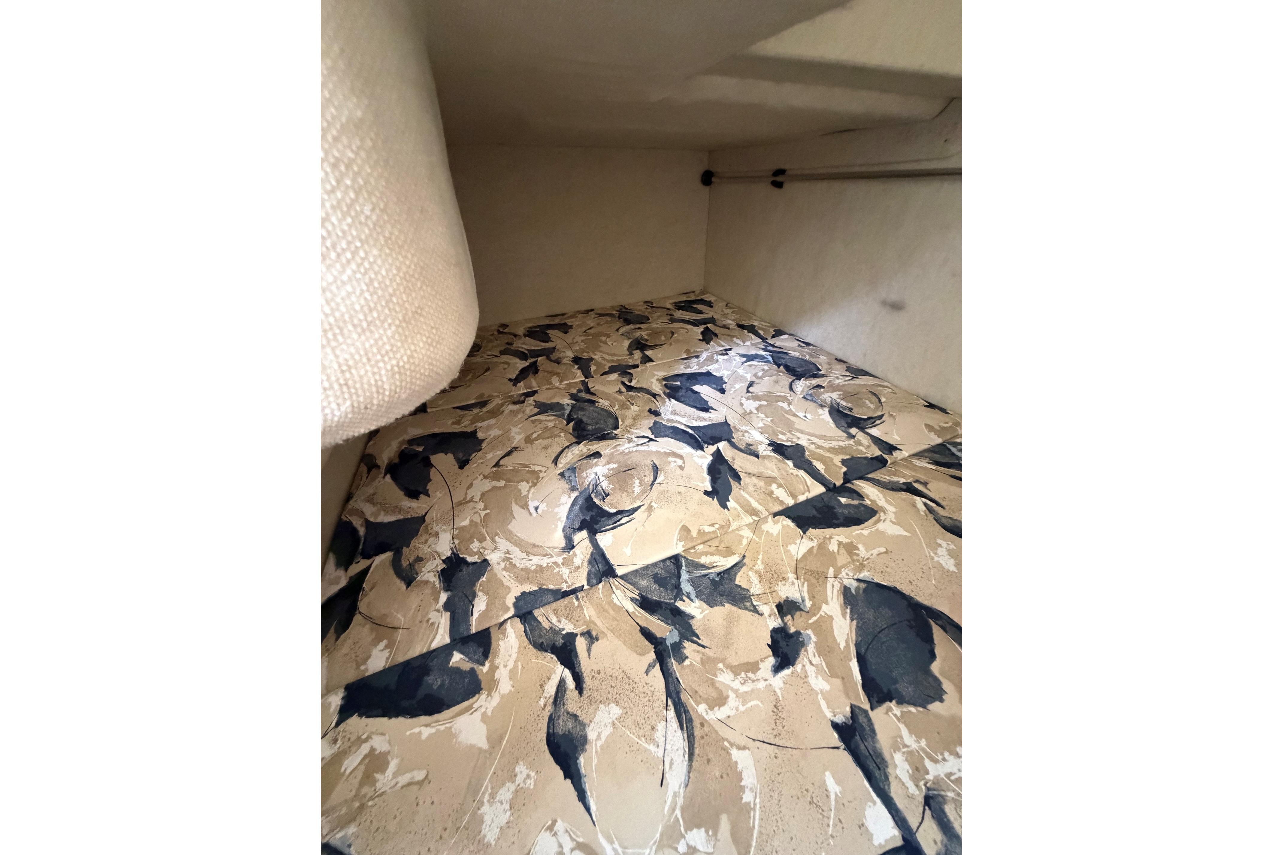 Interior cabin of 2000 Sea Ray 240 Sundancer with patterned upholstery.
