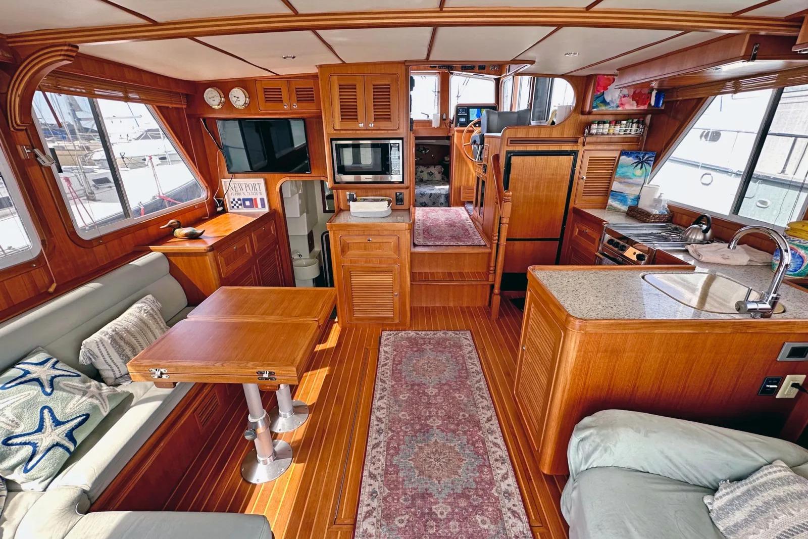 Luxurious interior of 2016 Helmsman Trawlers 38 Pilothouse with wood finish and modern amenities.