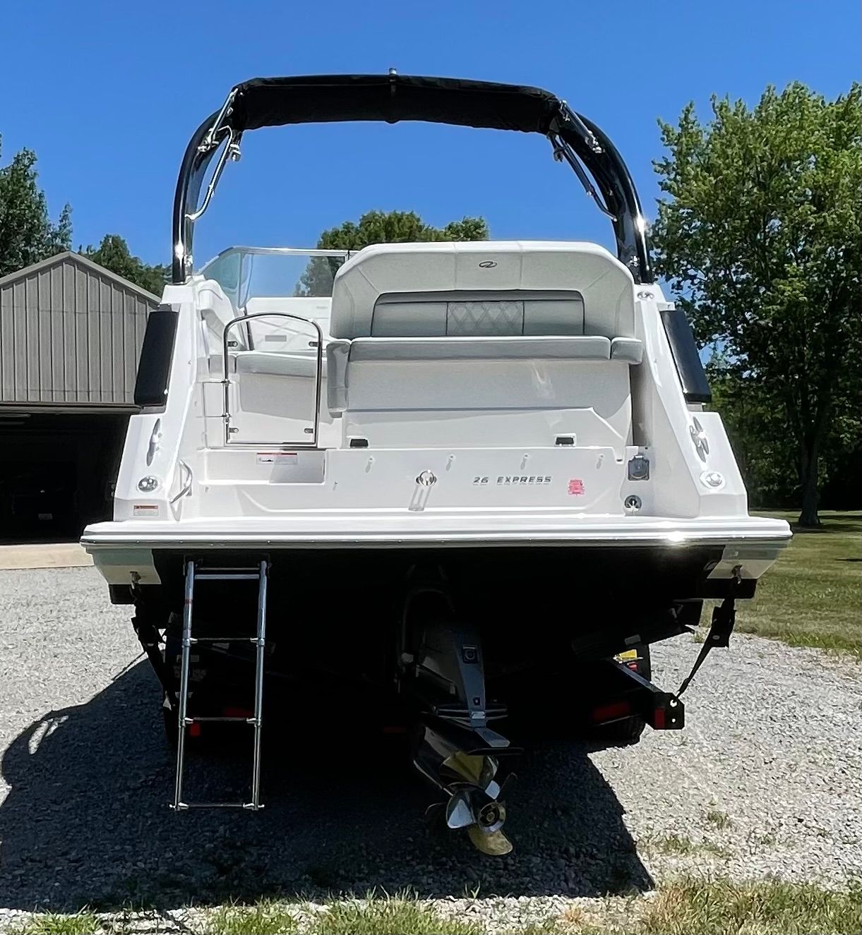 Rear view of a 2022 Regal 26 Express boat outdoors.