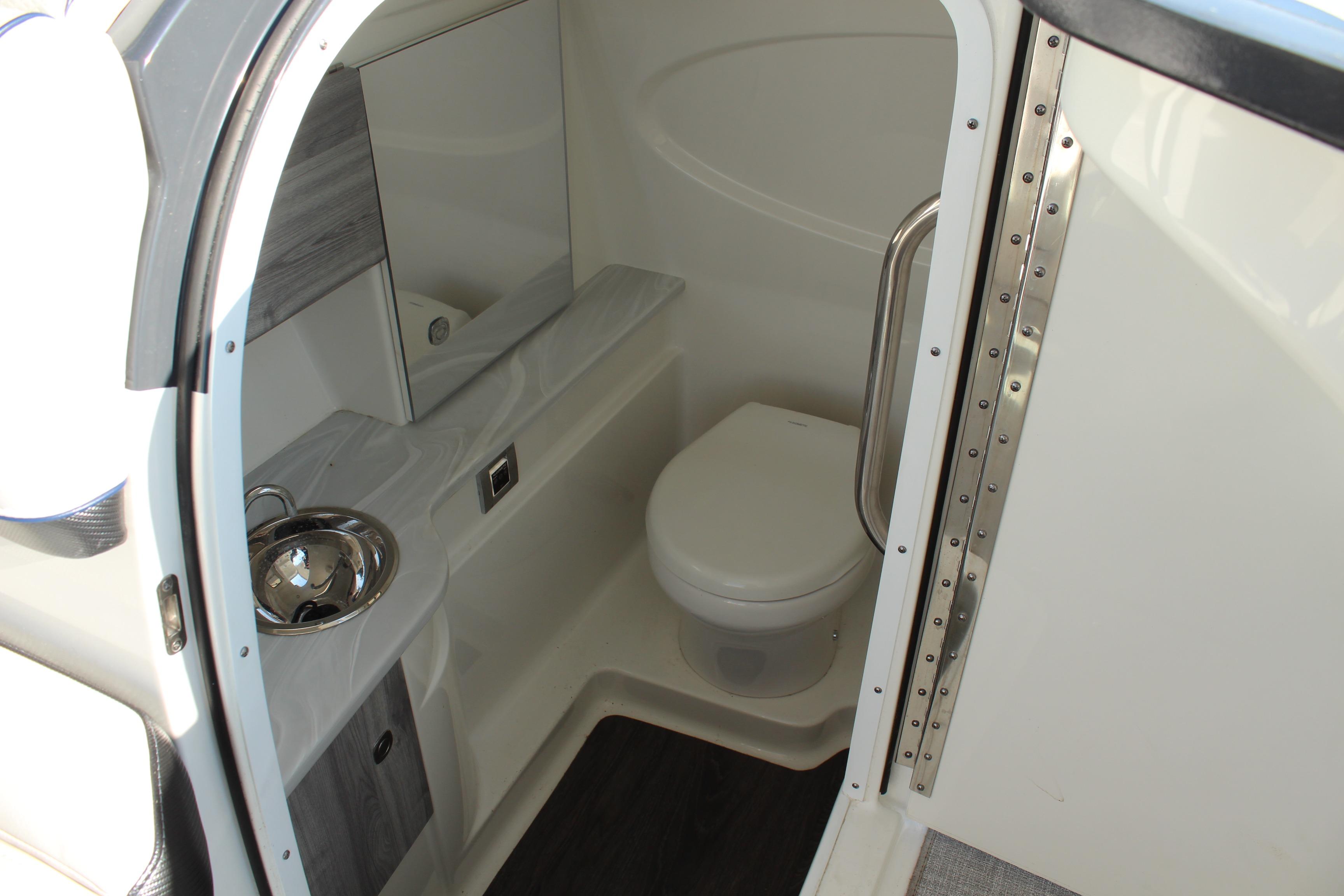 2023 Formula 310 Bowrider I/O boat bathroom interior with sink and toilet.