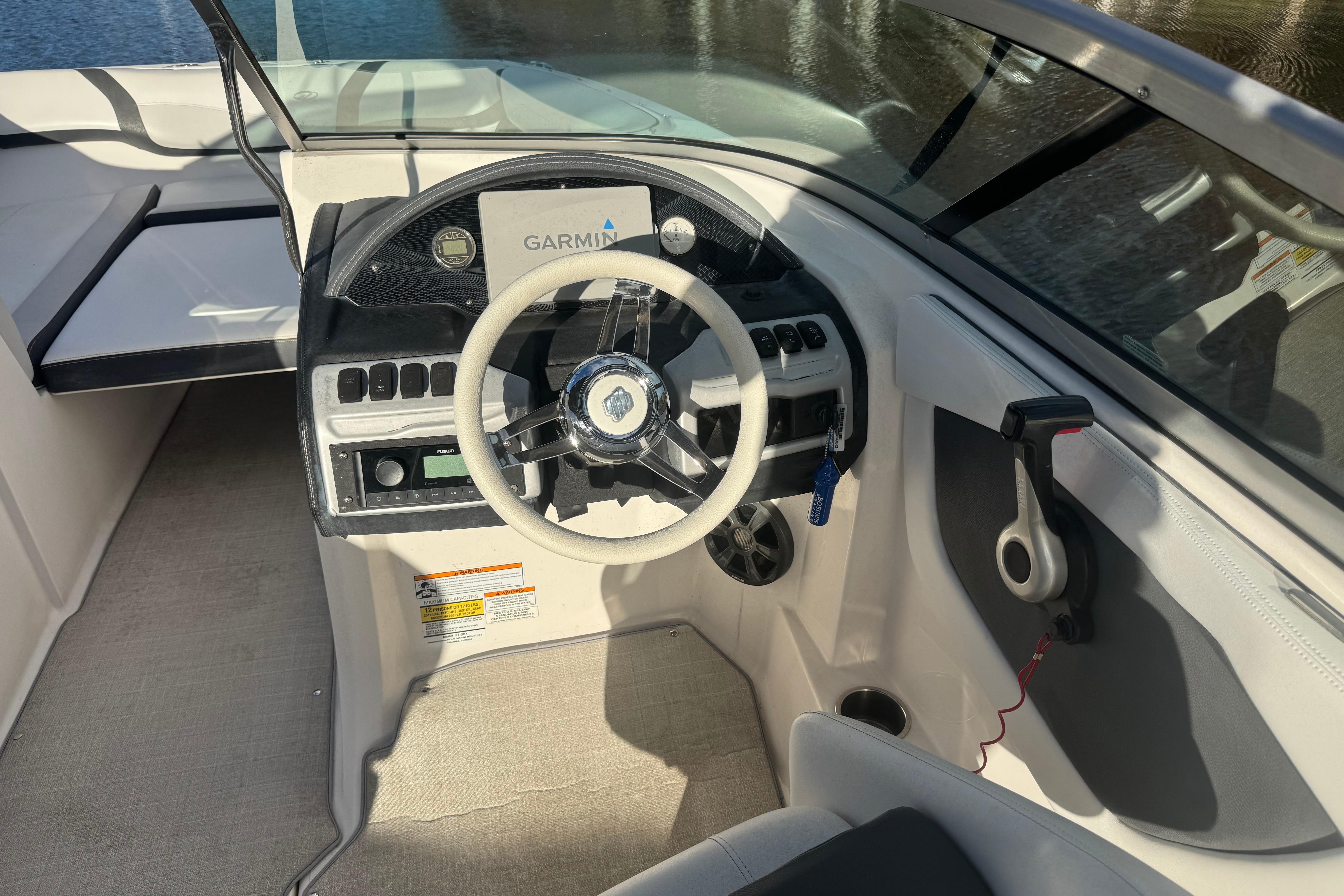 Cockpit of 2017 Regal 23 OBX boat with steering wheel and Garmin navigation system.