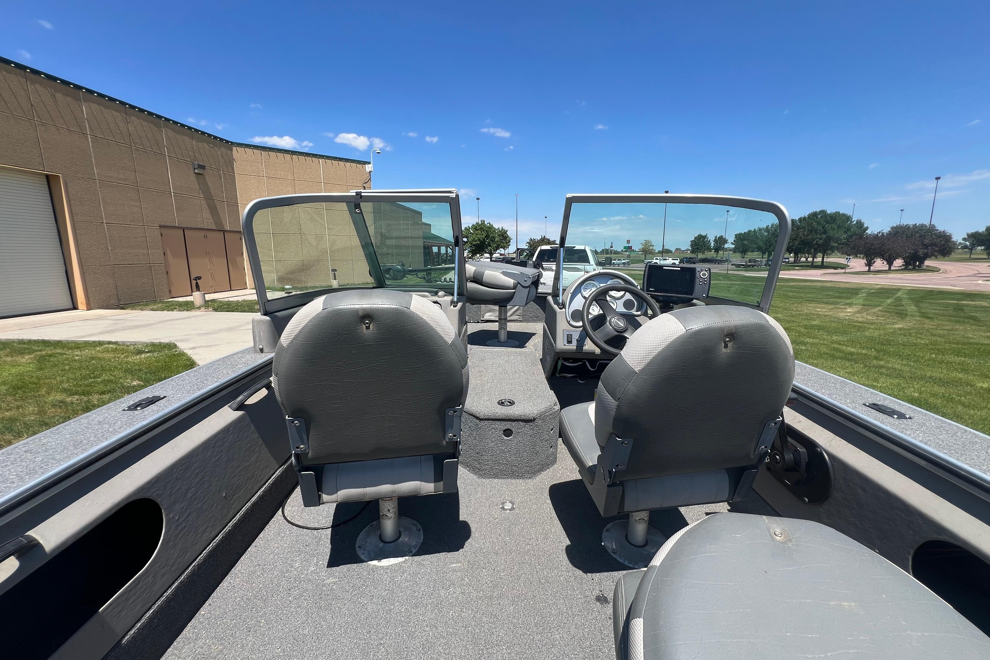 2010 Alumacraft Dominator 165 Sport boat interior with dual seats and steering console.
