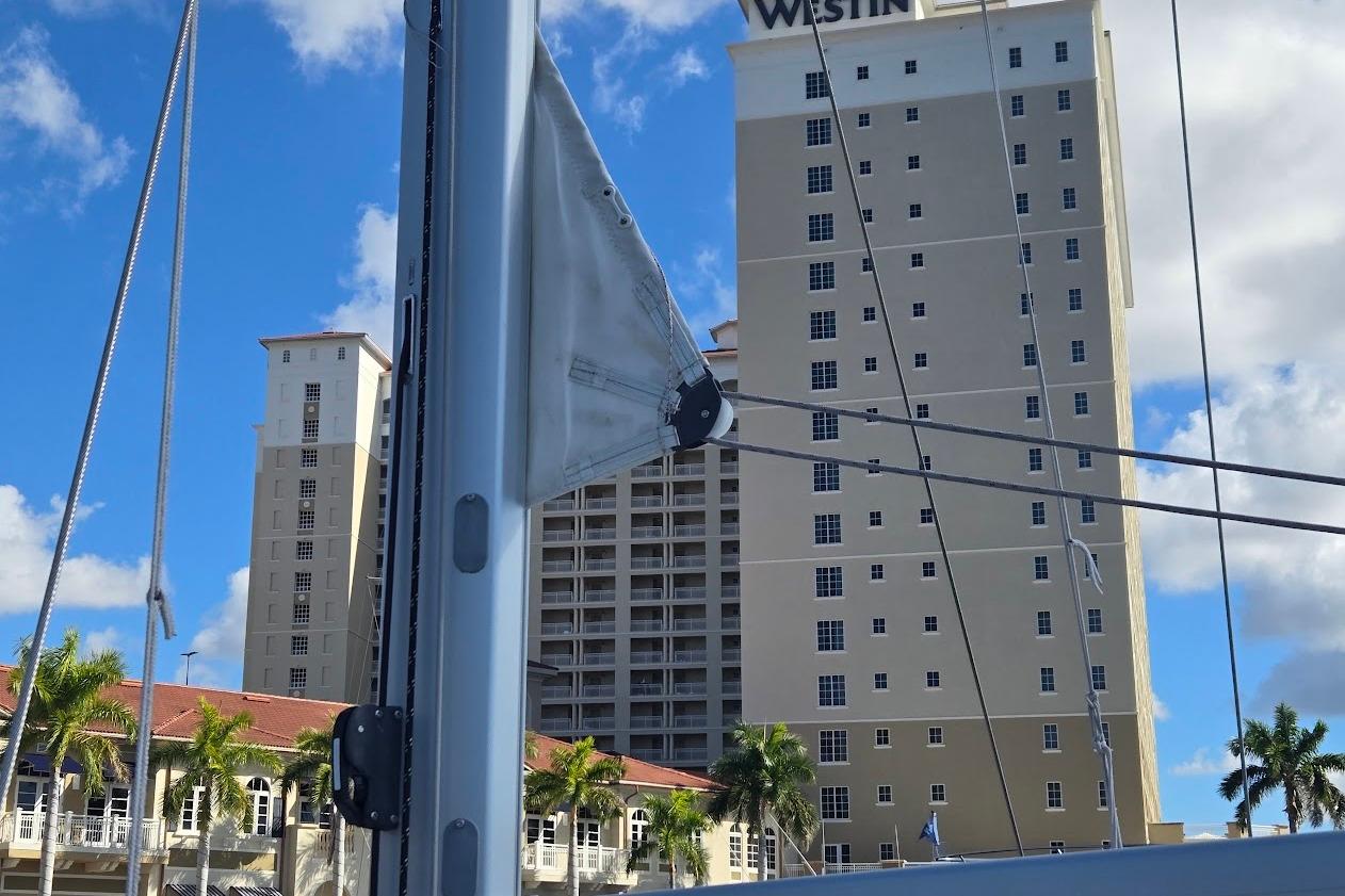 2023 Beneteau Oceanis 38.1 sailboat mast with cityscape background.