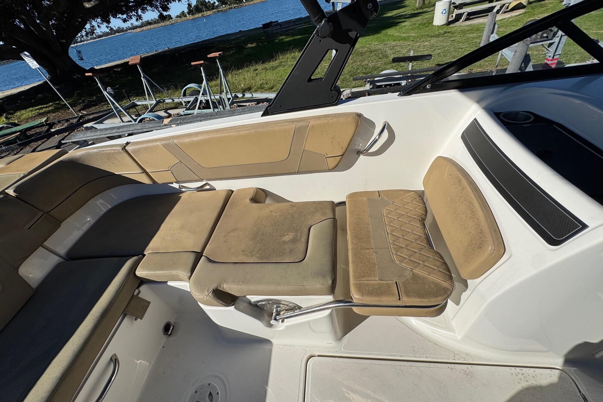 2022 Bayliner VR6 Bowrider OB interior with tan seating and lake view.