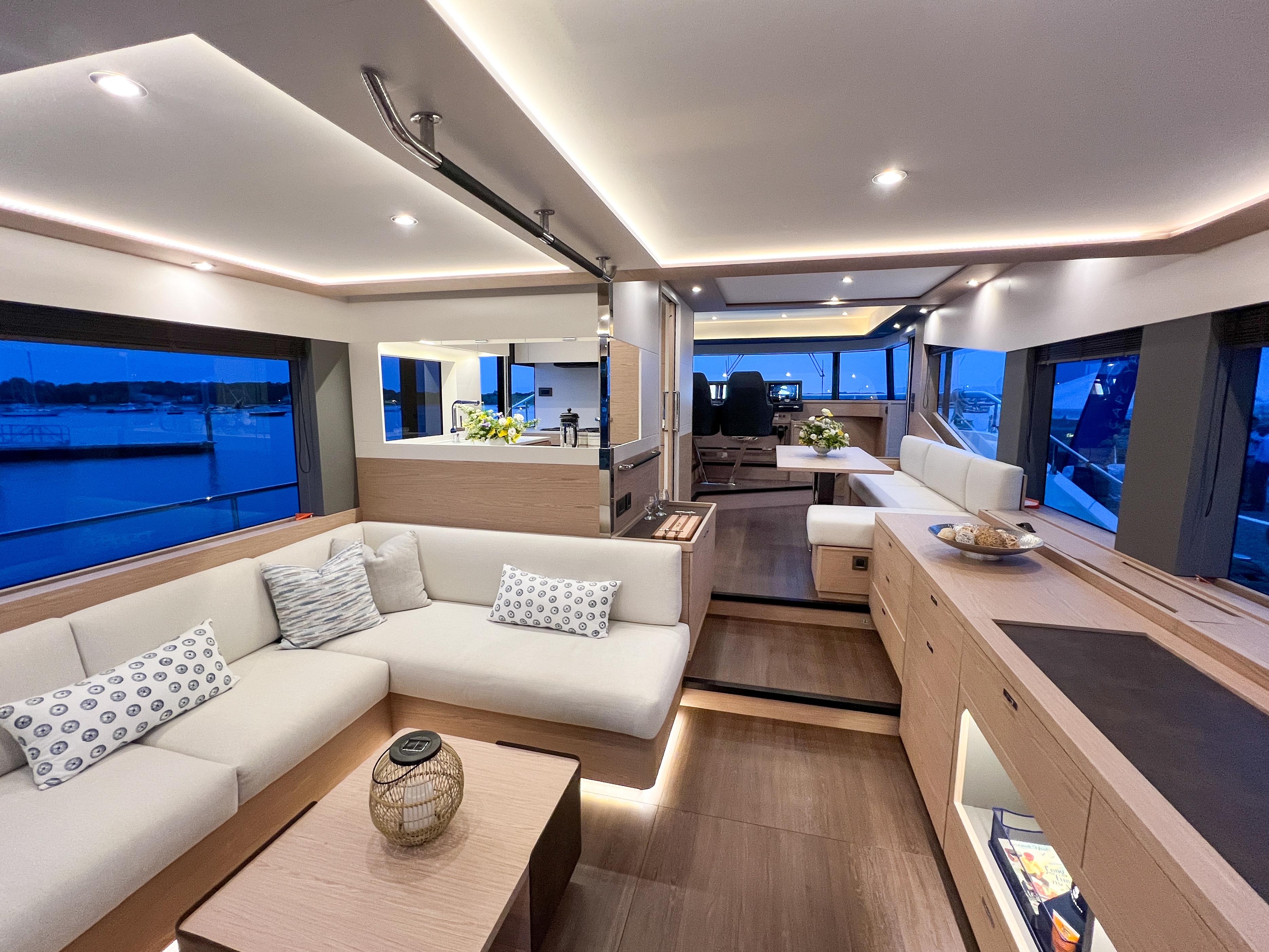 Luxurious interior of 2025 Beneteau Grand Trawler 62 with modern furnishings and ambient lighting.