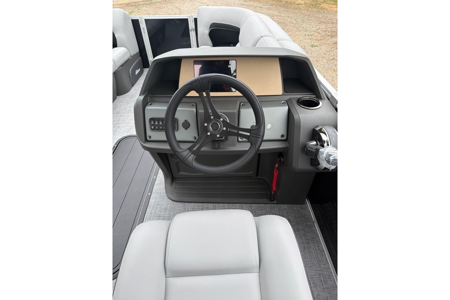 2026 Sun Tracker Party Barge 22 RF XP3 steering console with modern controls and seating.