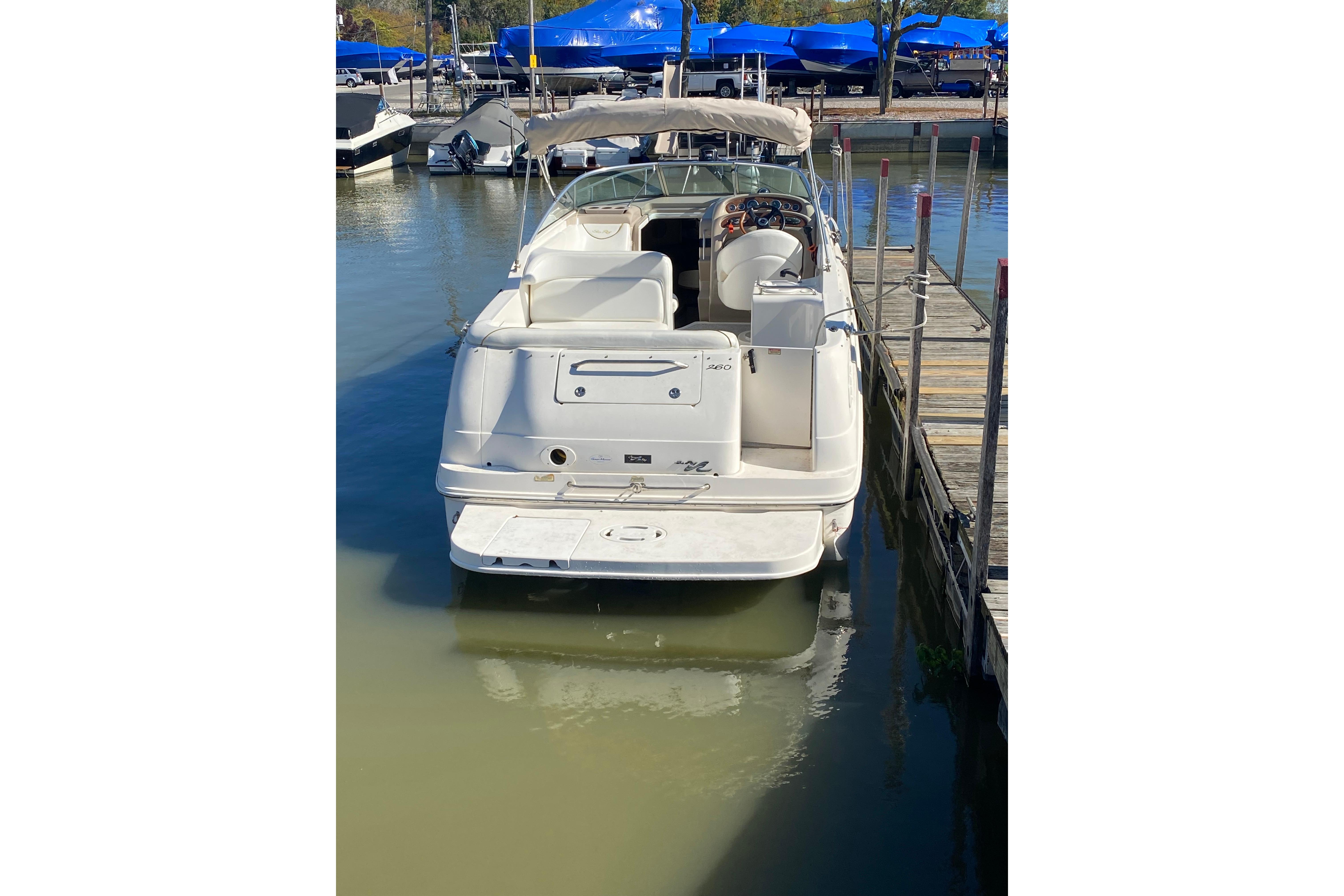 2001 Sea Ray Sundancer 260 docked at marina, rear view.