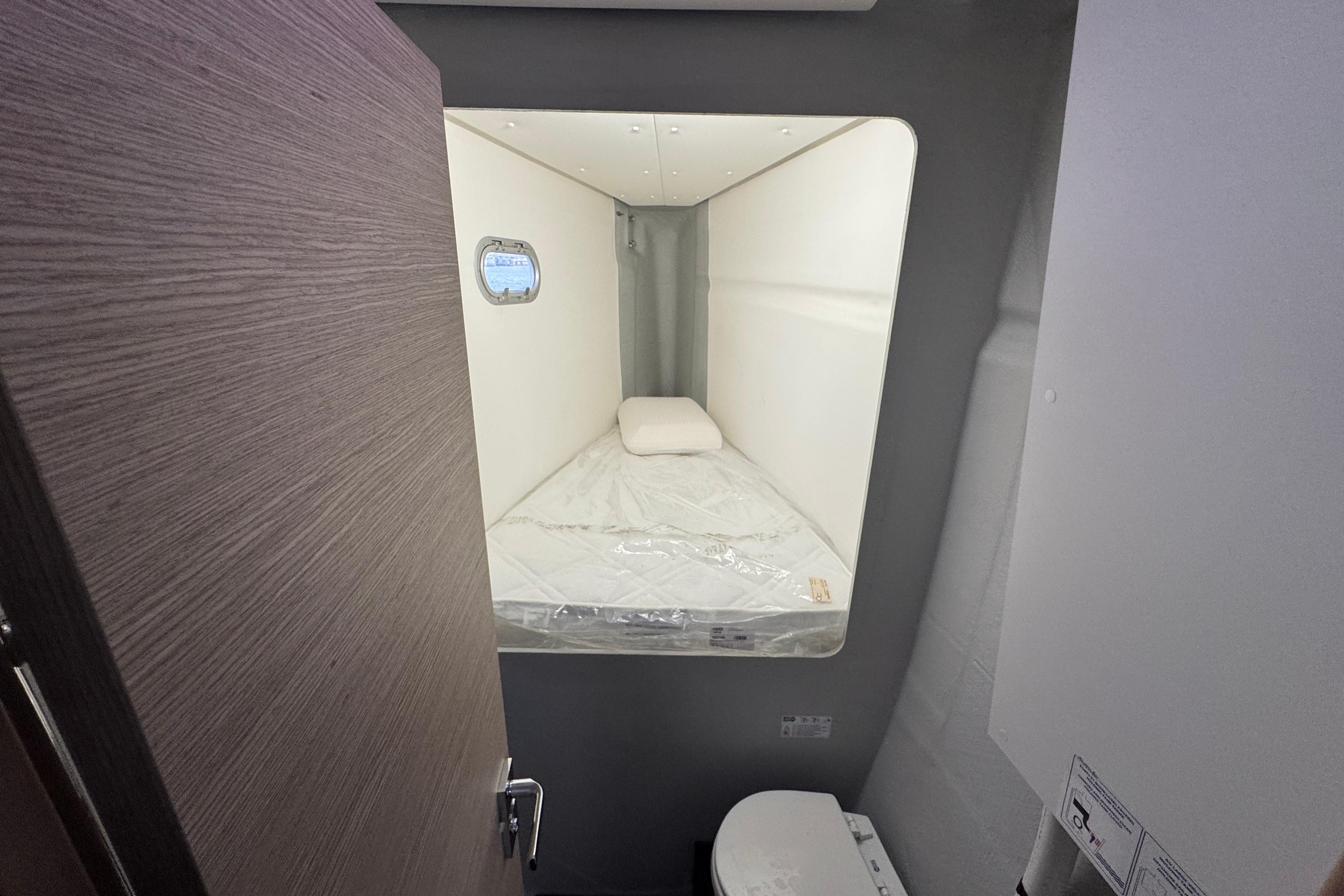 Cabin interior of 2021 Fountaine Pajot Saona 47 catamaran with bed and porthole.