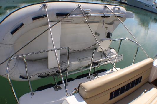 2019 Ranger Tugs R-31 CB with mounted dinghy on the stern, docked in calm waters.
