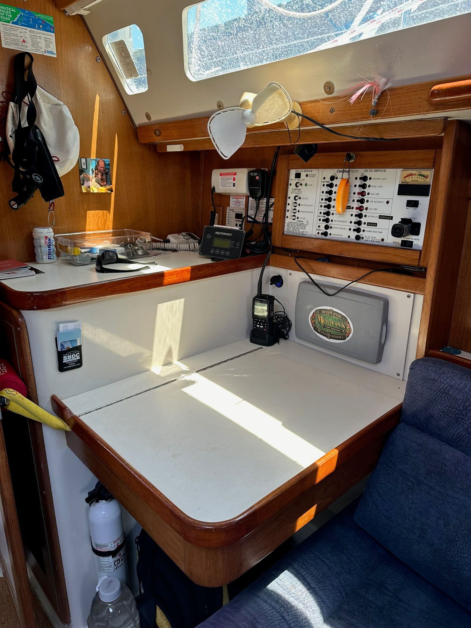 Interior of a Catalina MkII yacht with a navigation station and wood paneling.