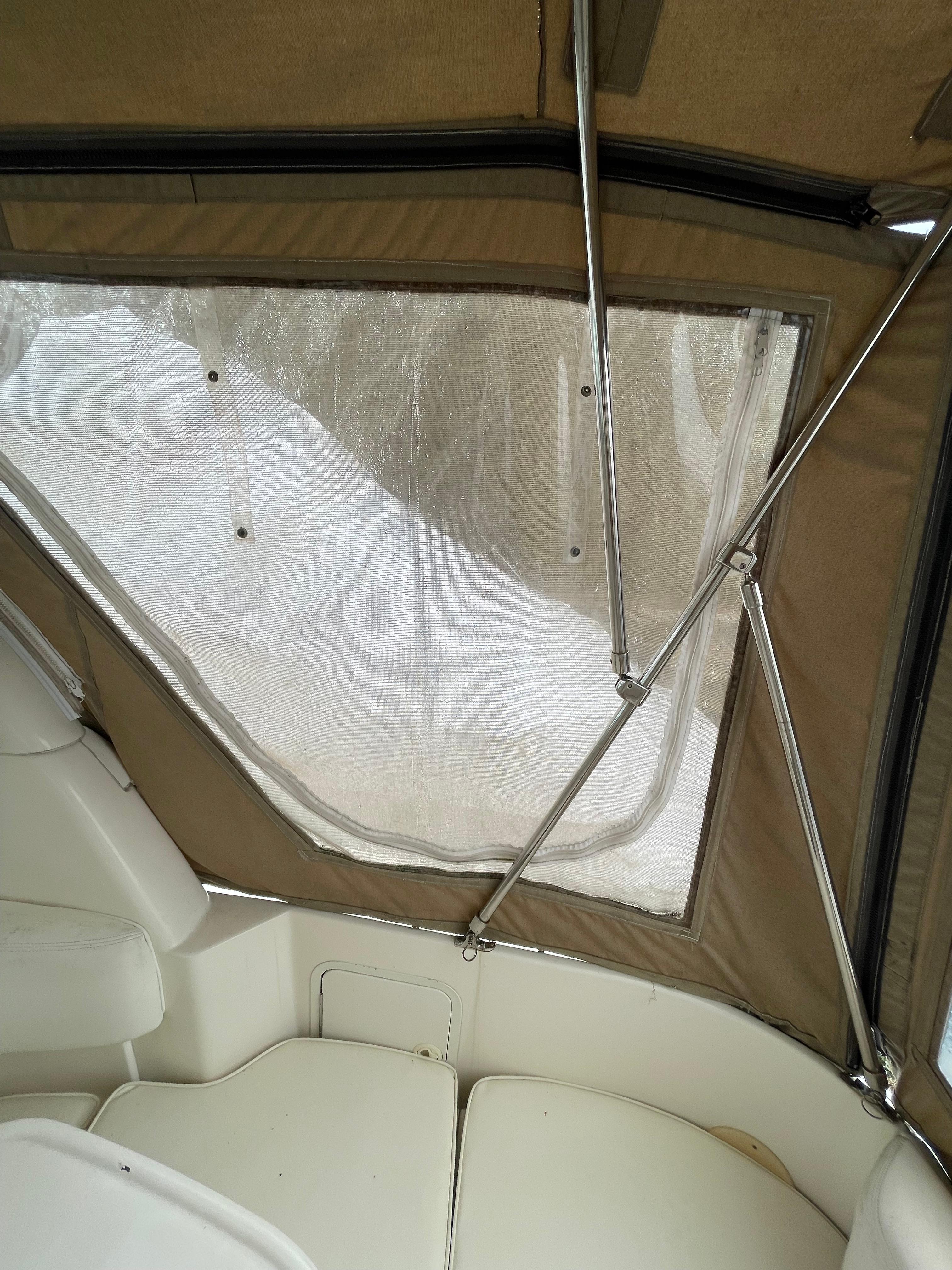 2001 Sea Ray 310 Sundancer interior with beige canopy and seating.