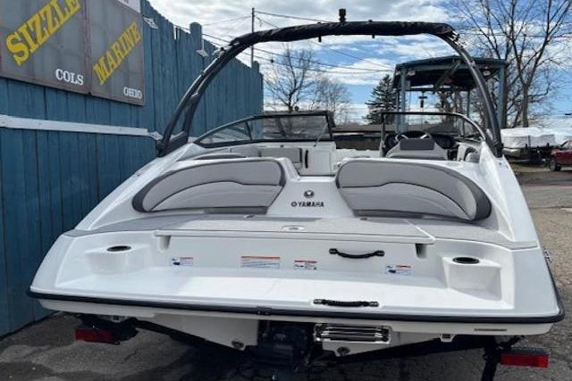 2026 Yamaha Boats AR190, sleek white design, parked outdoors near blue fence.
