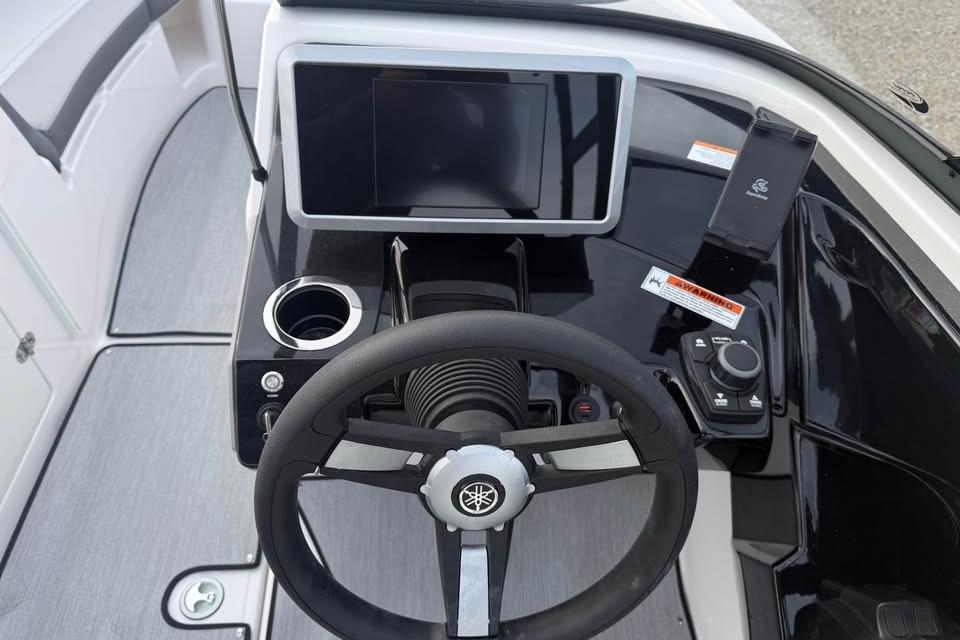 2026 Yamaha AR250 boat dashboard with steering wheel, touchscreen, and control panel.