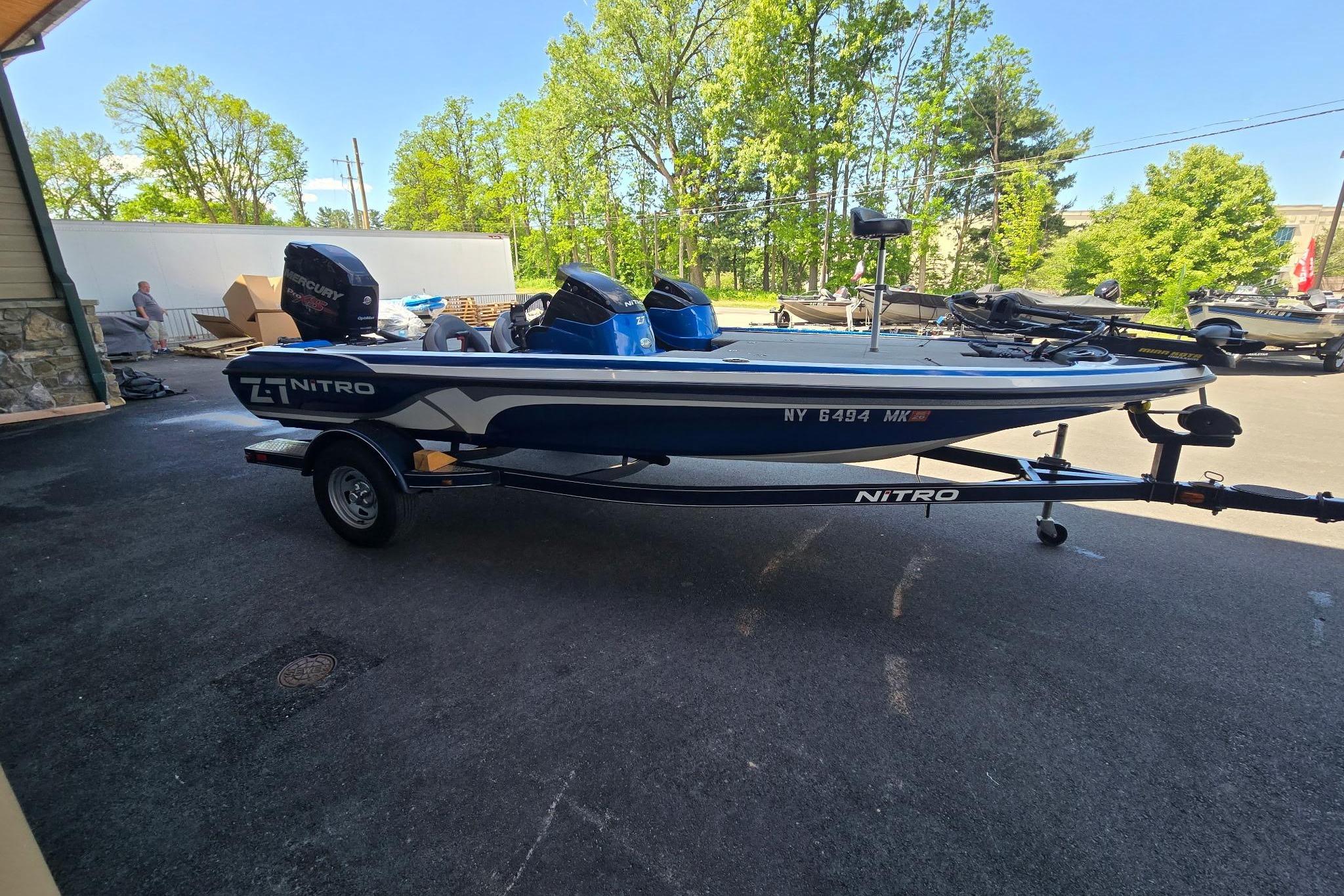 2014 Nitro Z-7 boat on trailer, parked outdoors with trees in background.