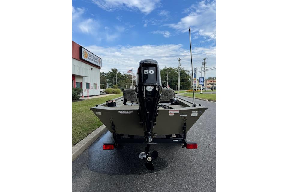2026 Tracker Grizzly 1754 SC boat with 60 HP motor, parked outdoors.