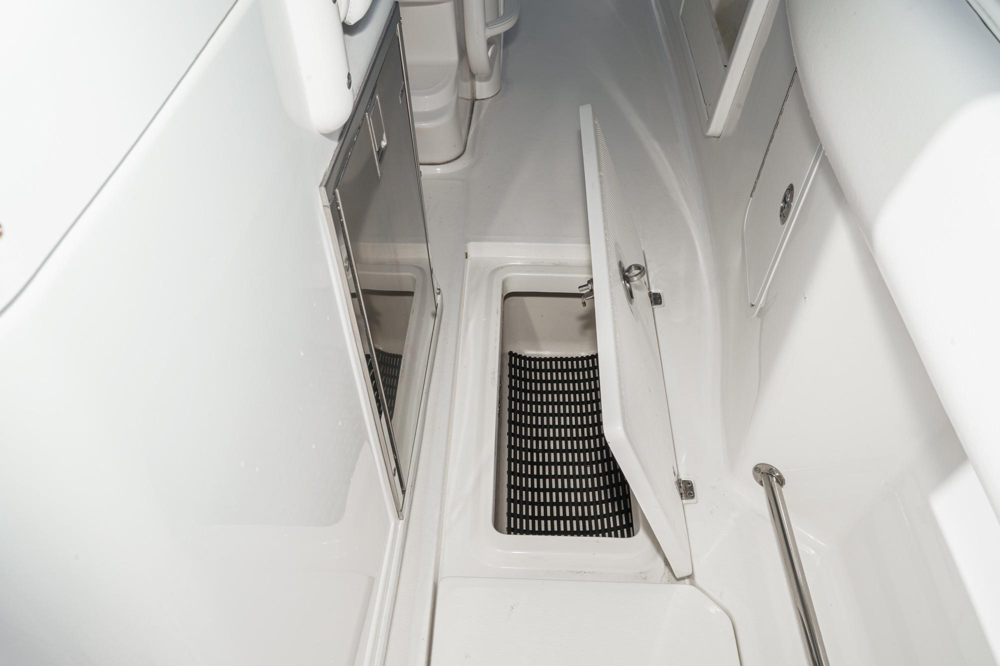 Interior view of 2015 Boston Whaler 370 Outrage boat, featuring storage compartments.