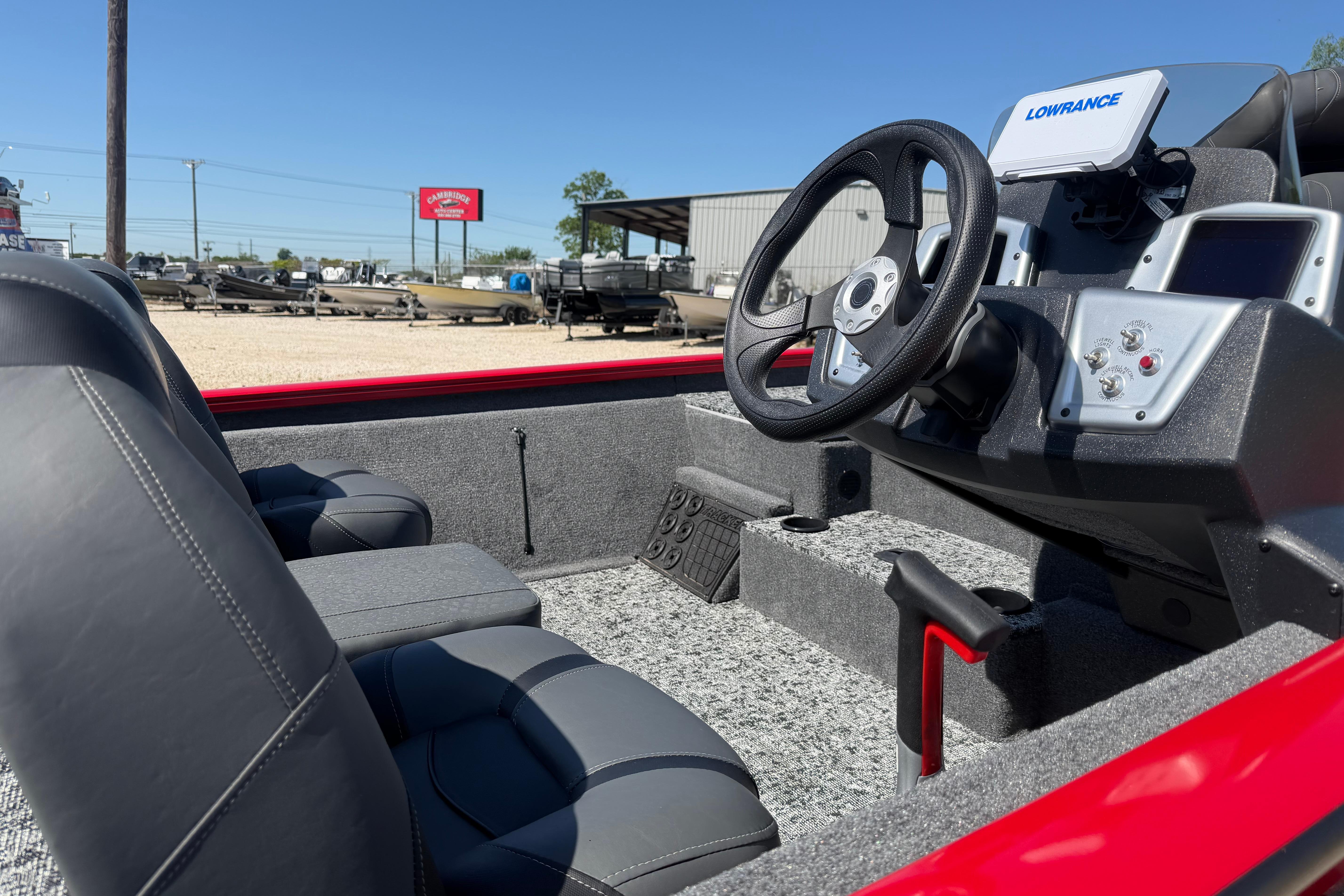 2026 Tracker Pro Team 195 boat interior with steering wheel and seats, featuring Lowrance electronics.