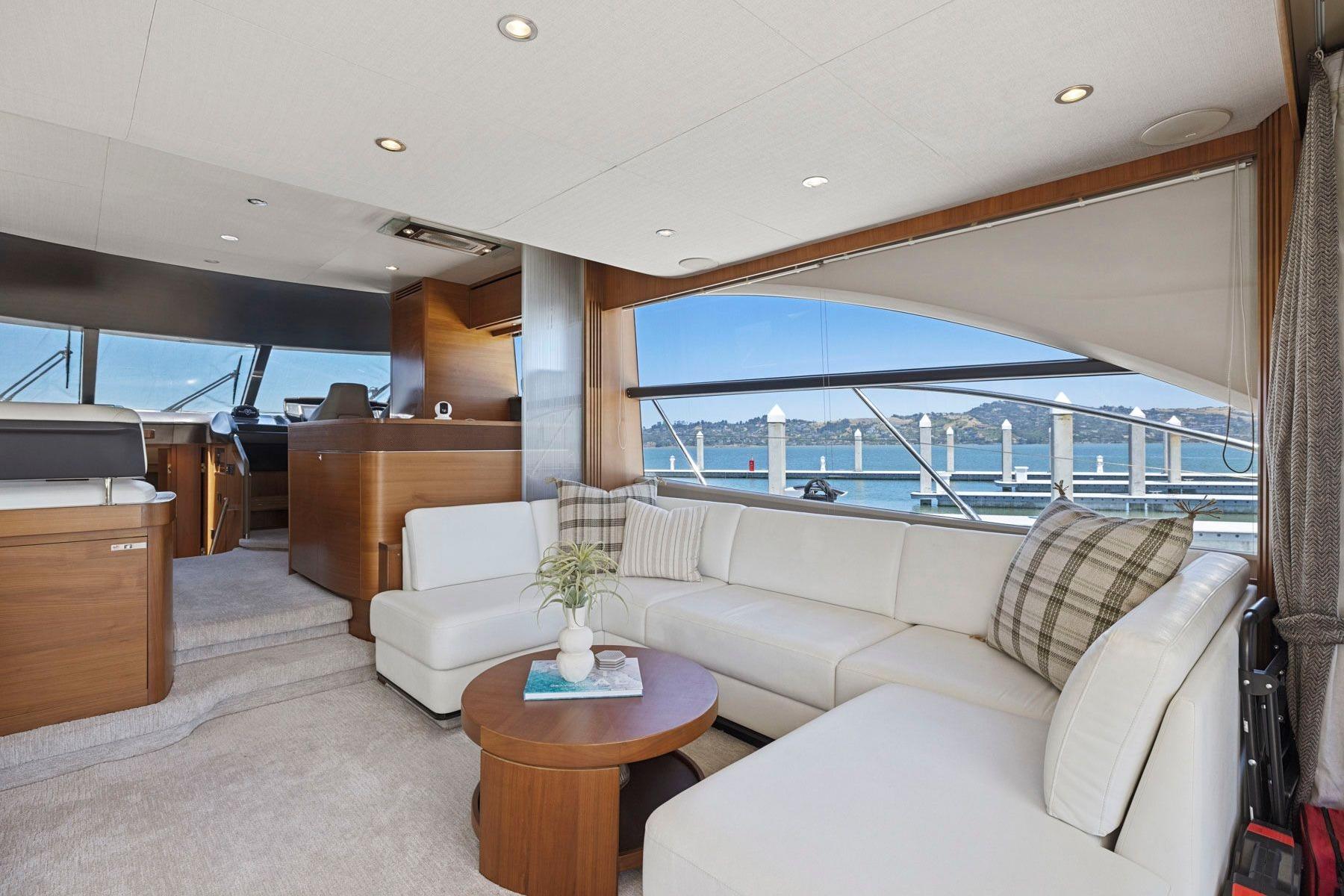 Luxurious interior of 2015 Princess 60 Flybridge Motor Yacht with elegant seating and scenic views.