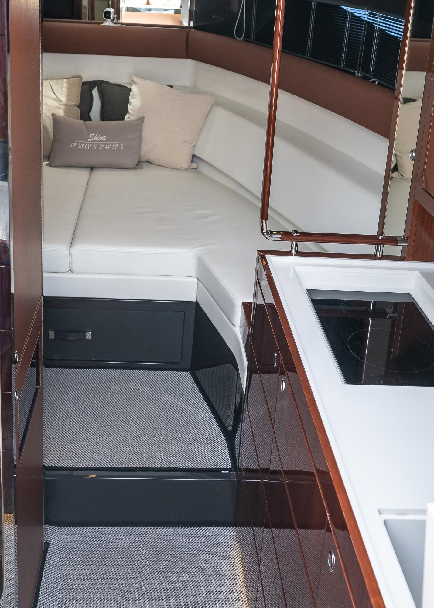 2022 Riva Rivamare yacht interior with modern kitchen and cozy seating area.