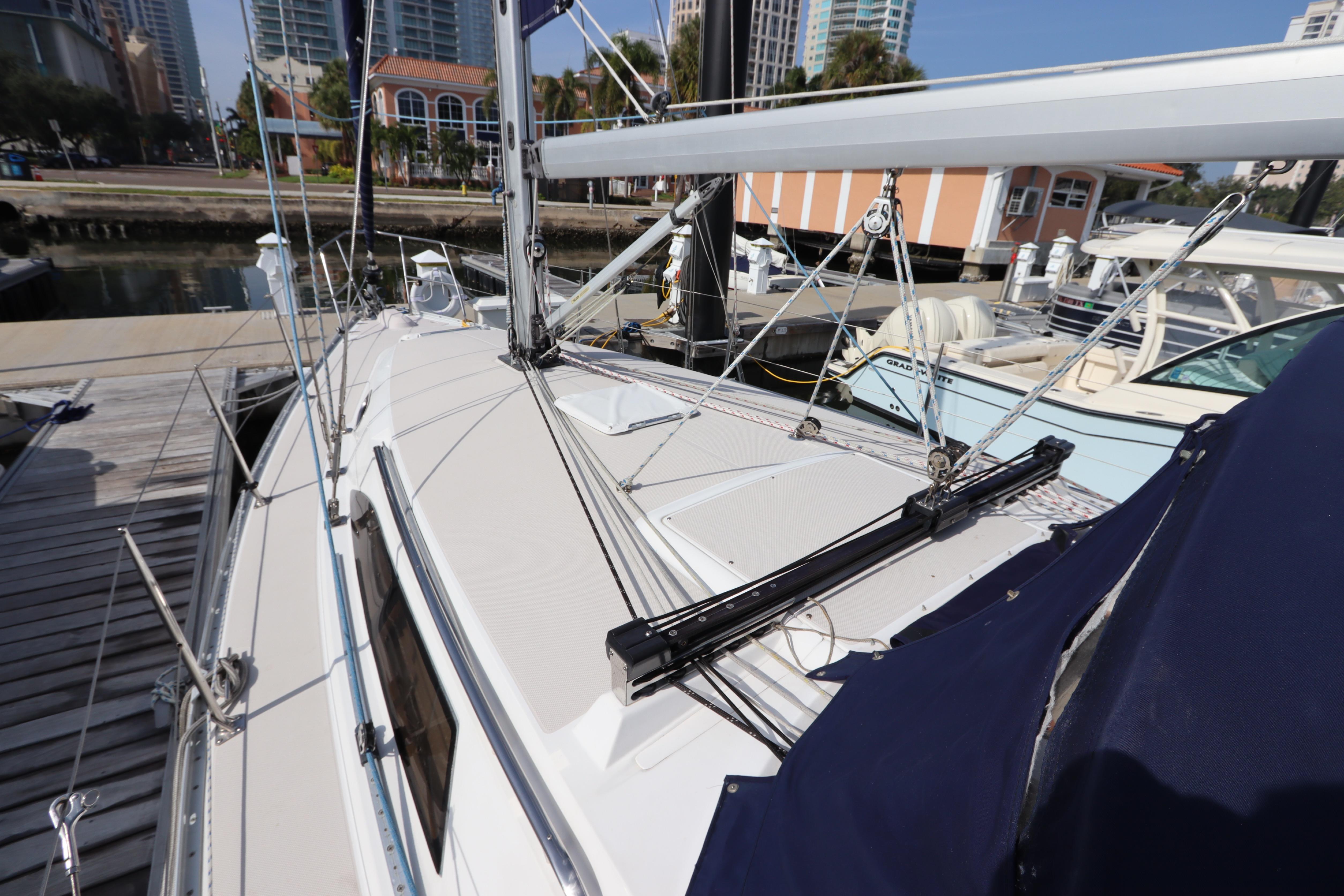 Sailboat Catalina 355, 2011 model, docked at marina with cityscape background.