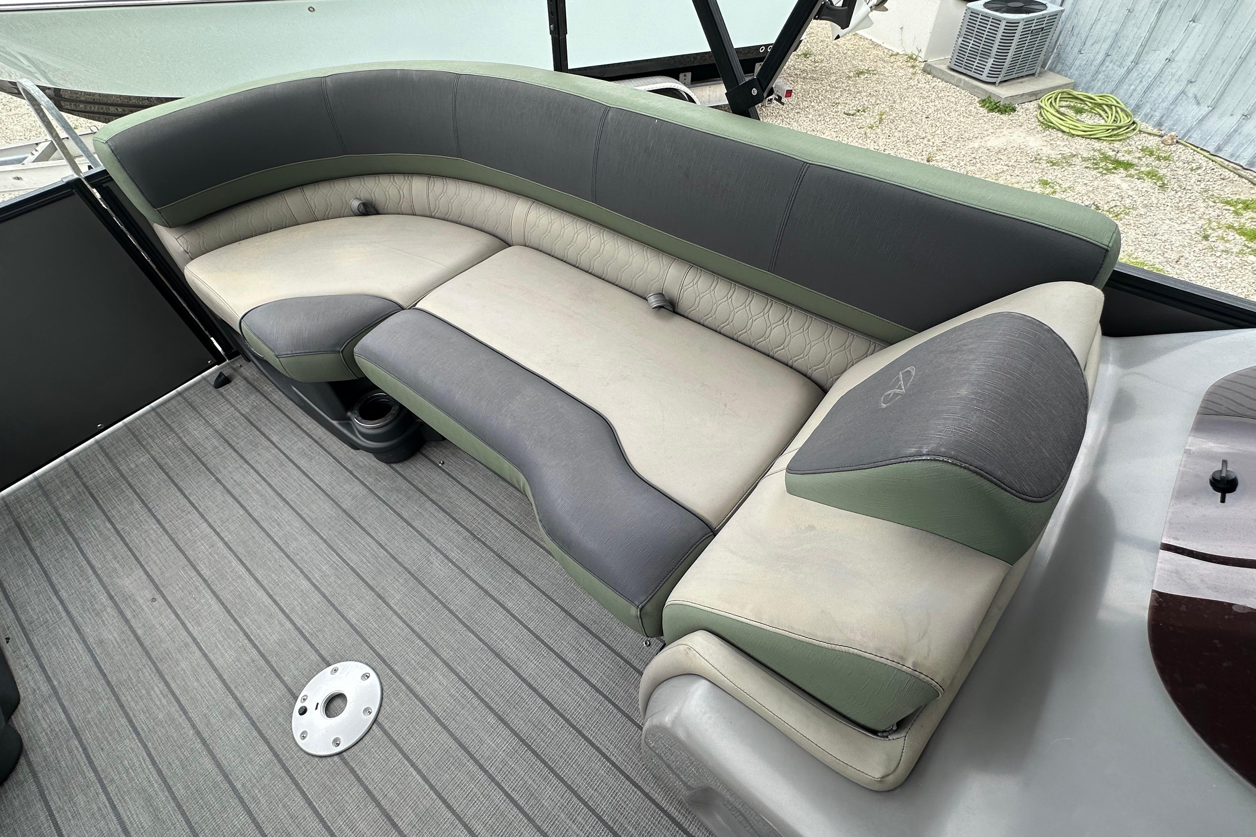 2023 Avalon Catalina Quad Lounge boat interior with gray and green seating.