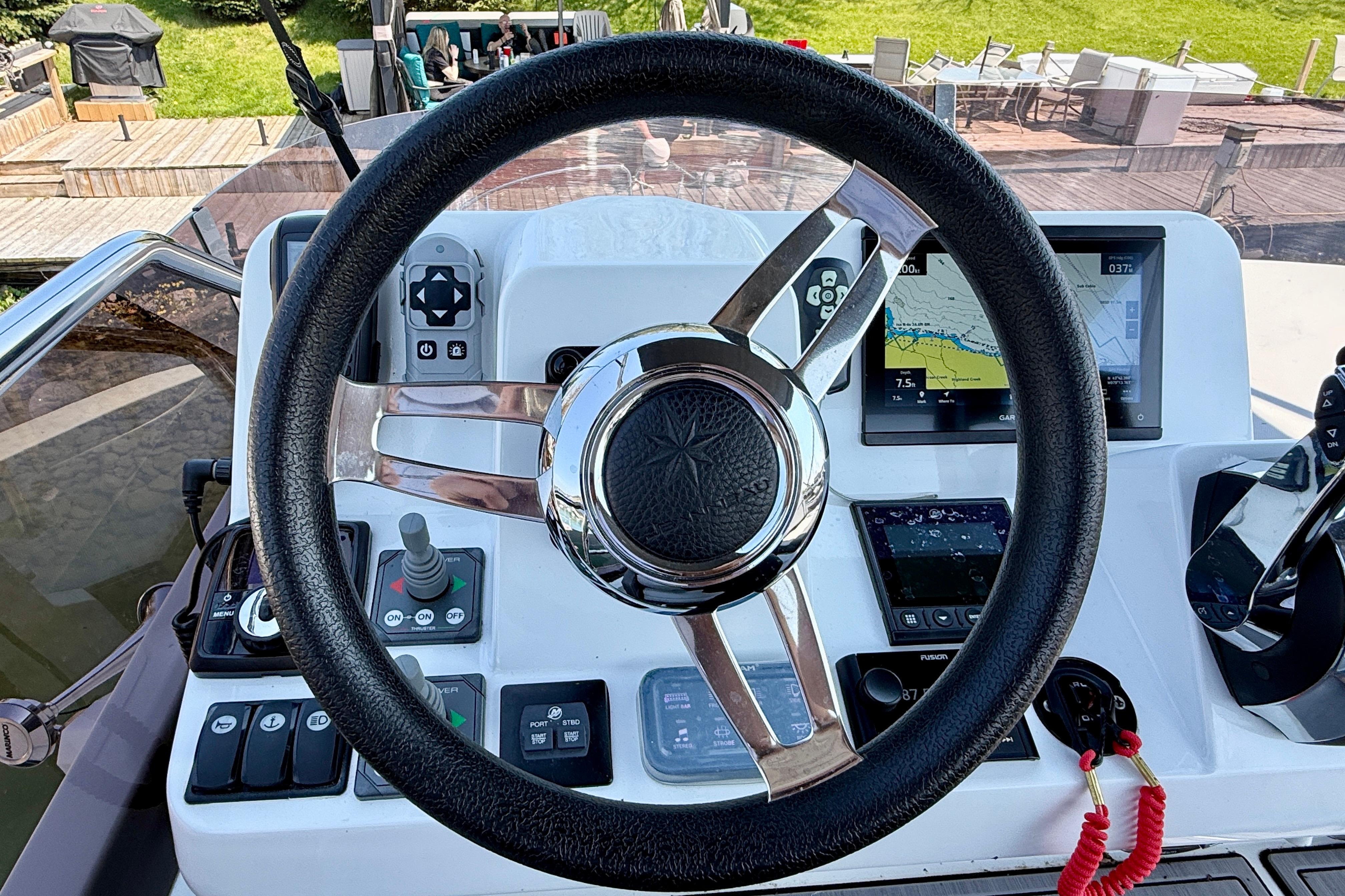Steering wheel and controls of 2022 Jeanneau NC 1095 Fly boat cockpit.