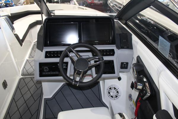 2025 Cobalt R6 boat cockpit with modern steering wheel and dual display screens.