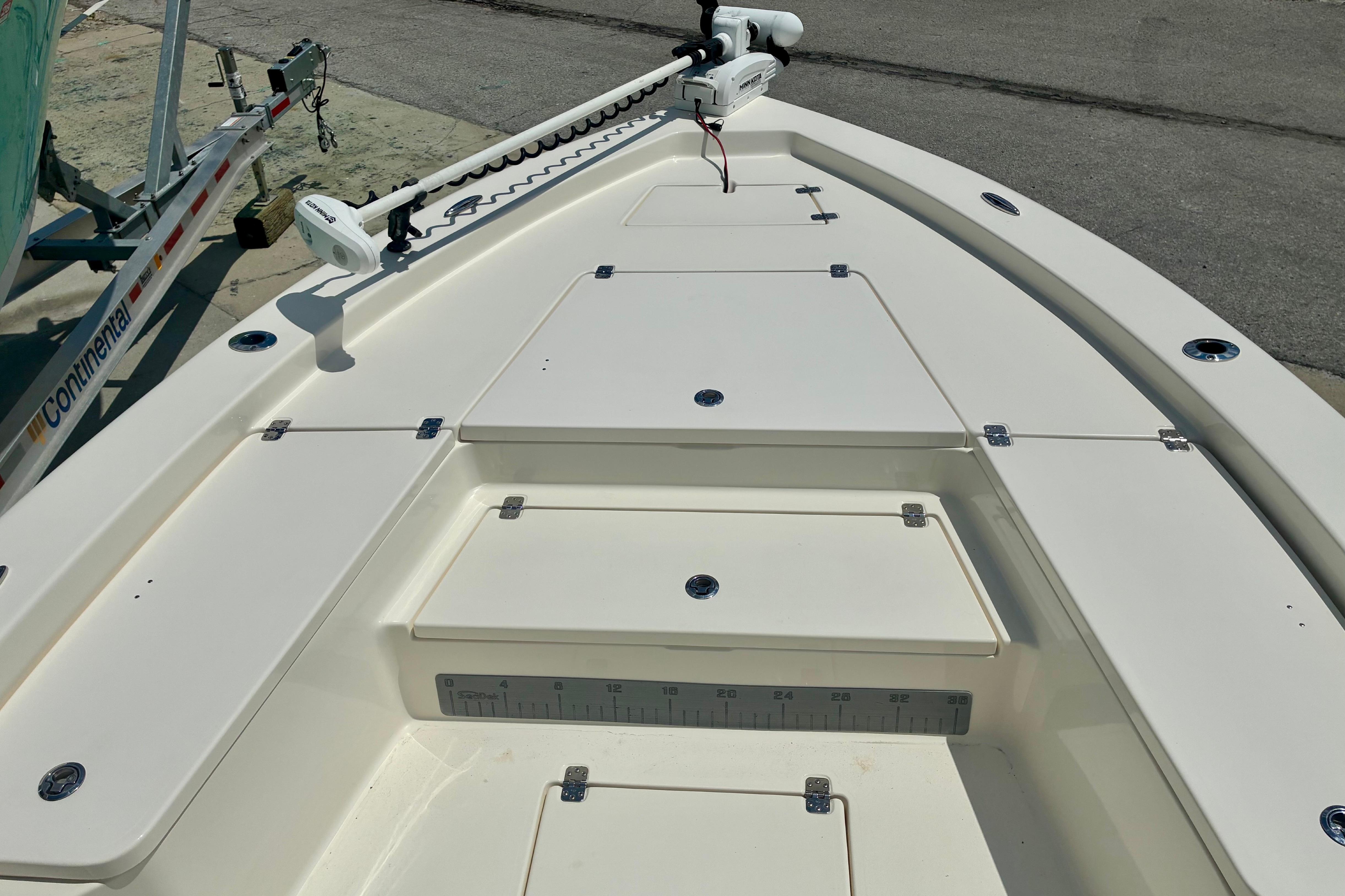 2018 Avenger AV24 boat deck with storage compartments and trolling motor.