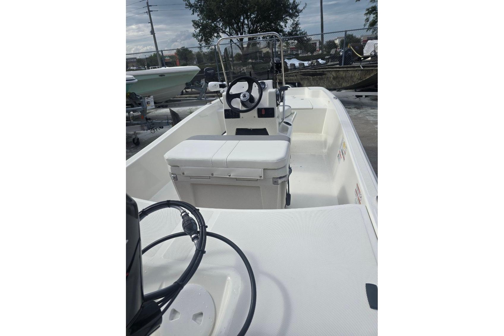 2026 Mako Pro Skiff 15 CC boat interior with steering console and seating.