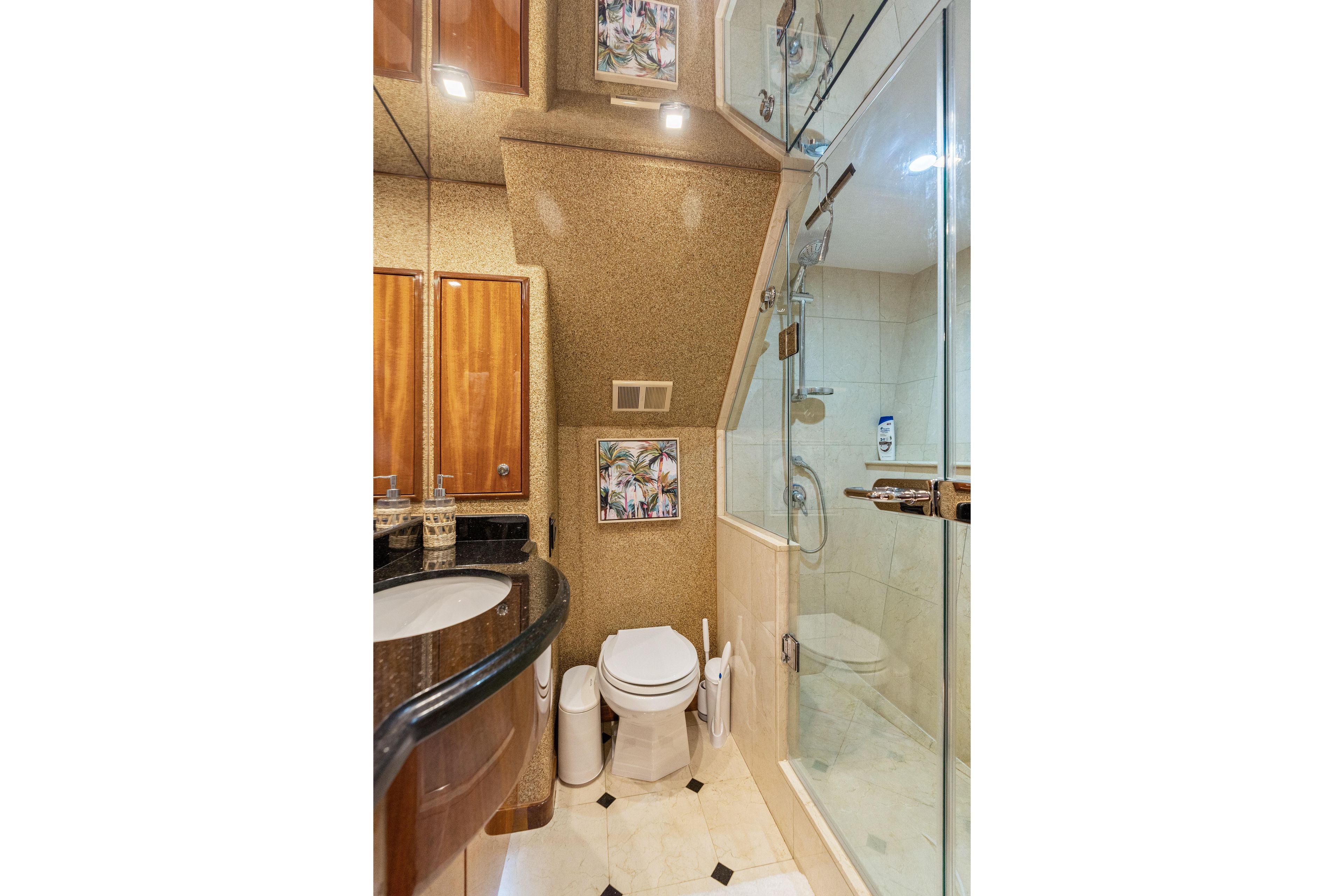 Luxurious bathroom in 2008 Hatteras 64 Motor Yacht with glass shower and elegant fixtures.