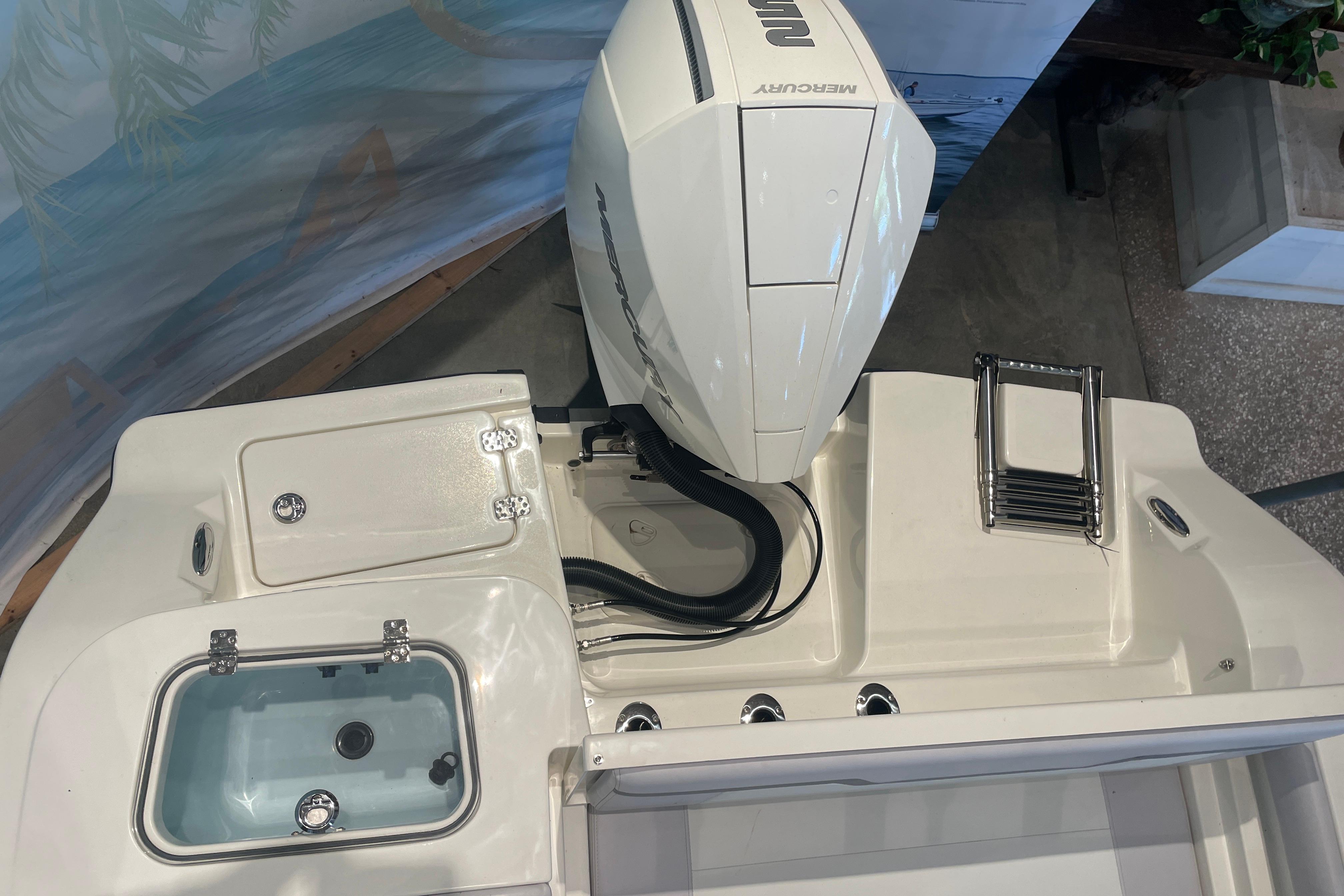 2026 Mako 226 Center Console boat with Mercury engine and integrated storage compartments.