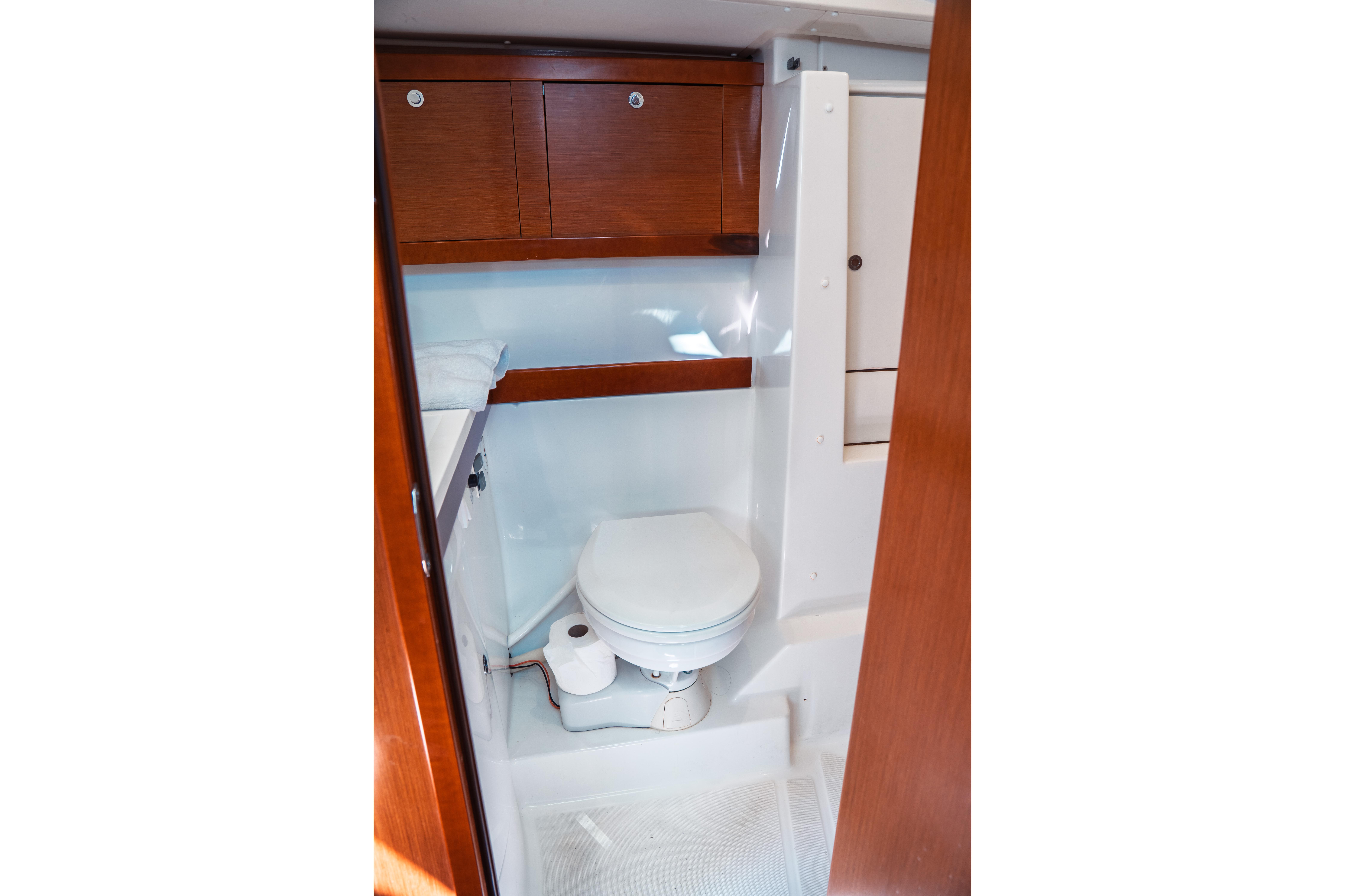 Bathroom interior of 2011 Beneteau Oceanis 50 yacht with wooden cabinets.
