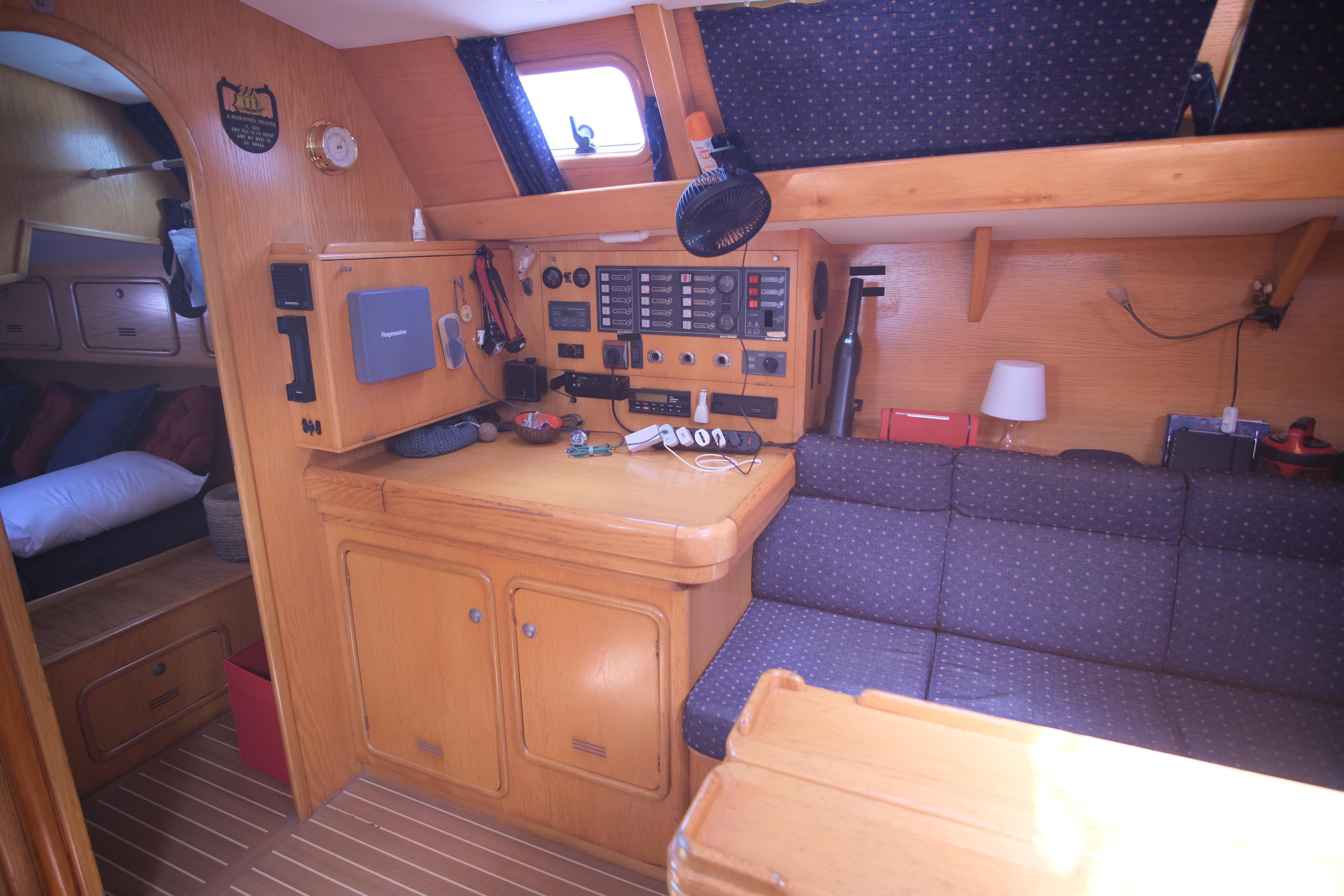Interior of 2003 Alubat OVNI 435 yacht with navigation equipment and cozy seating area.