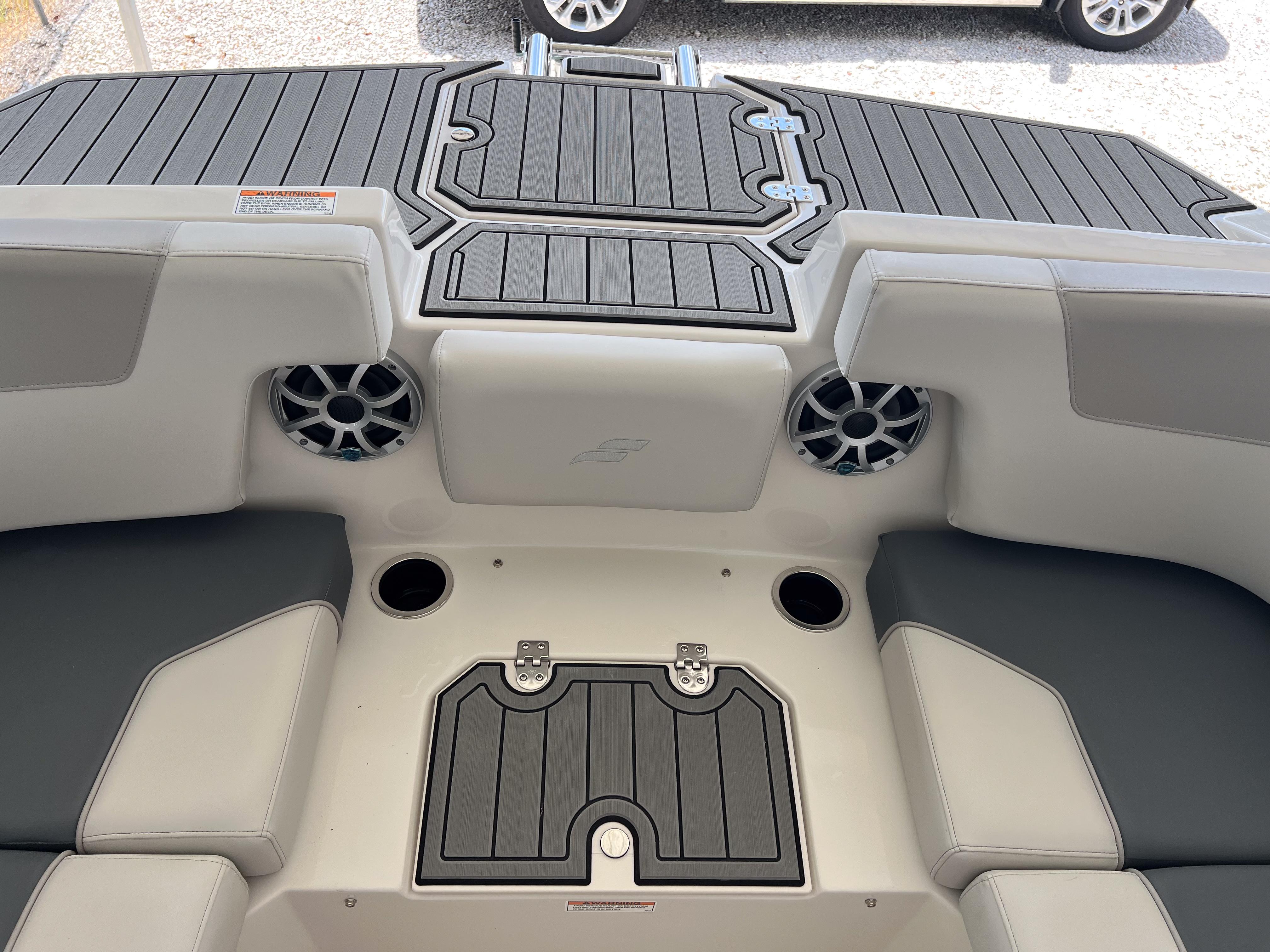 2026 Starcraft SVX 231 OB boat interior with seating, speakers, and storage compartments.