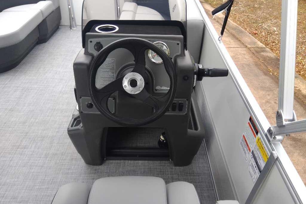 2026 Sun Tracker Party Barge 16 DLX steering console with modern controls and seating.