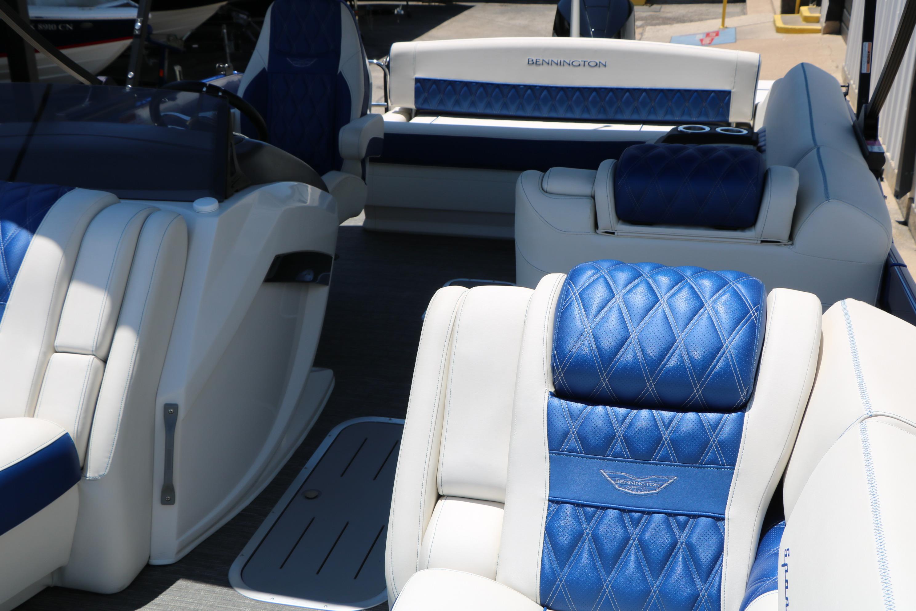 Luxurious interior of 2024 Bennington 23 RX Swingback with blue and white seating.
