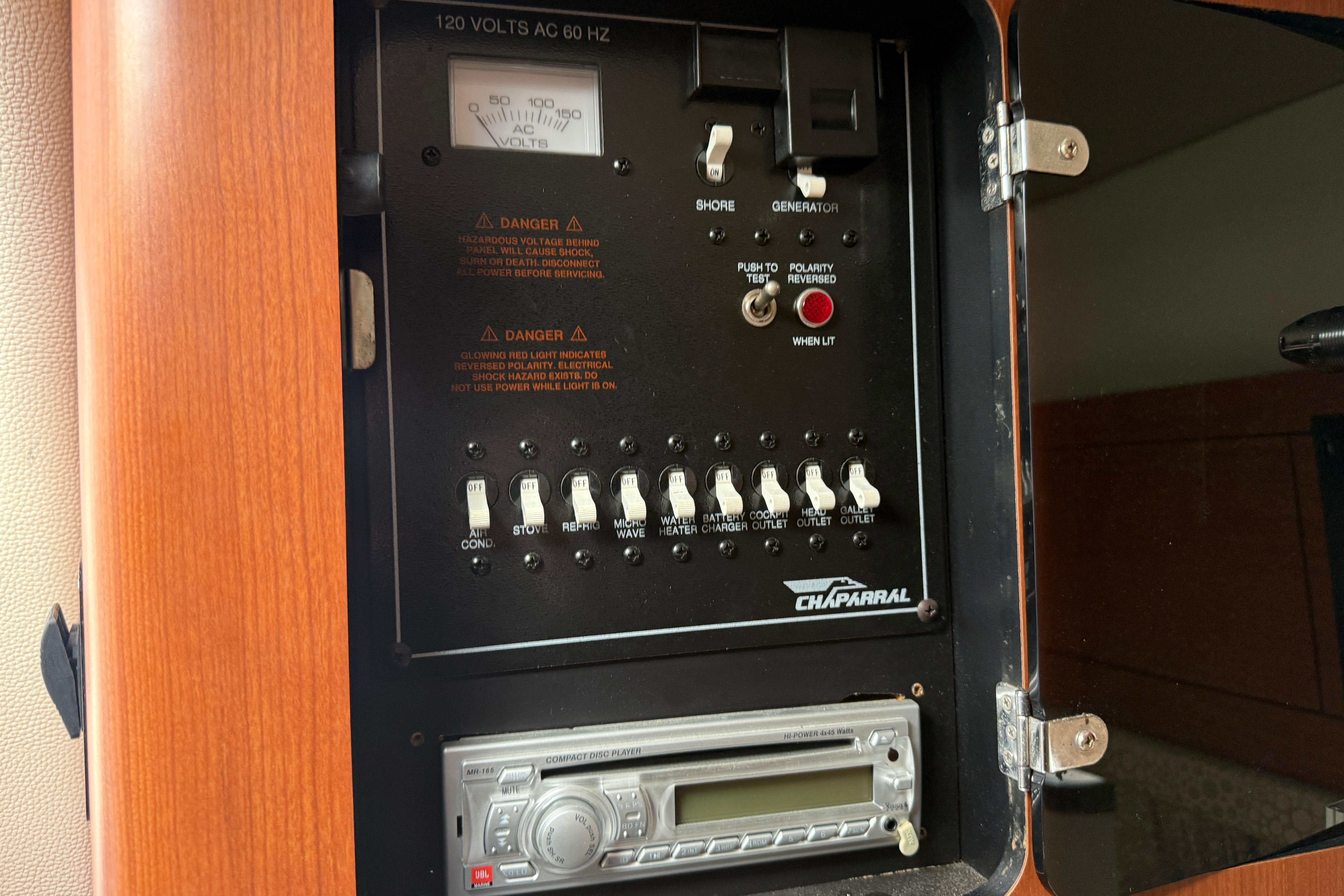Electrical panel of 2003 Chaparral Signature 280 boat with switches and CD player.