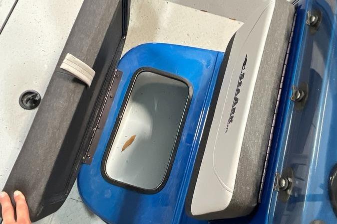 2025 SeaArk Shadow 187T boat storage compartment with open lid and visible interior.