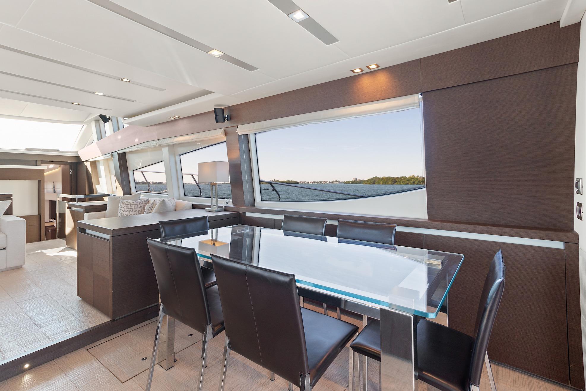 Luxurious interior of 2015 Prestige 750 yacht with modern dining area and panoramic windows.