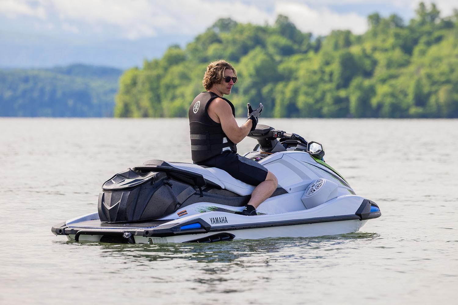 Manufacturer Provided Image: Man riding 2026 Yamaha WaveRunner VX Deluxe on a scenic lake.